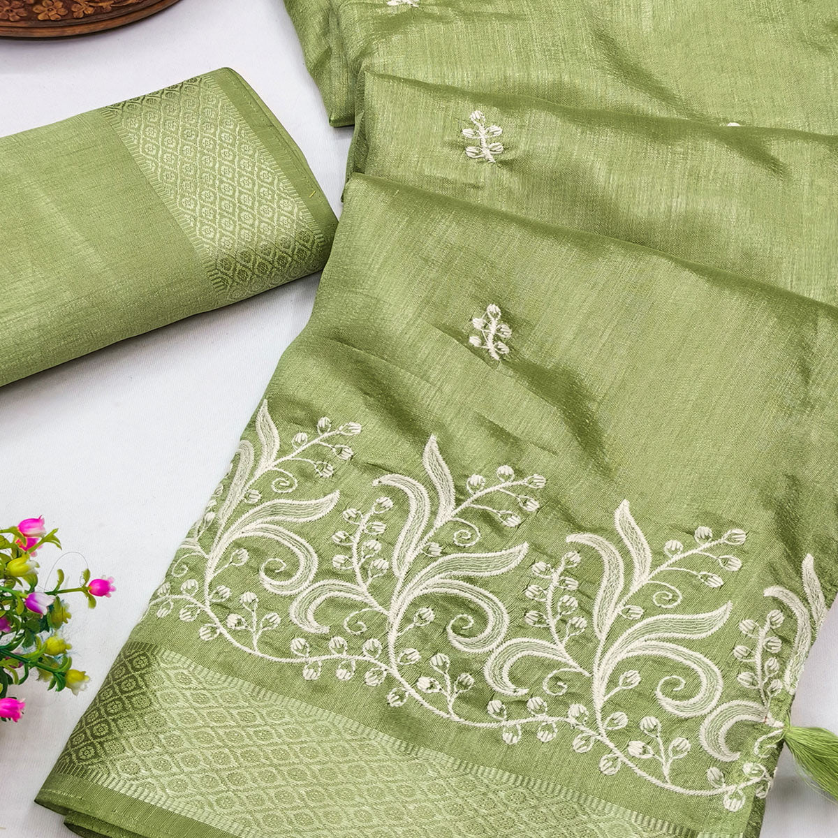 Green Art Silk Saree Adorned With Delicate Floral Embroidery & Stylish Tassel Pallu