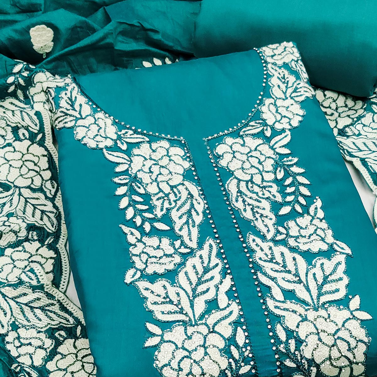 Teal Green Rich Viscose Dress Material Highlighted with Refined Floral Thread Embroidery