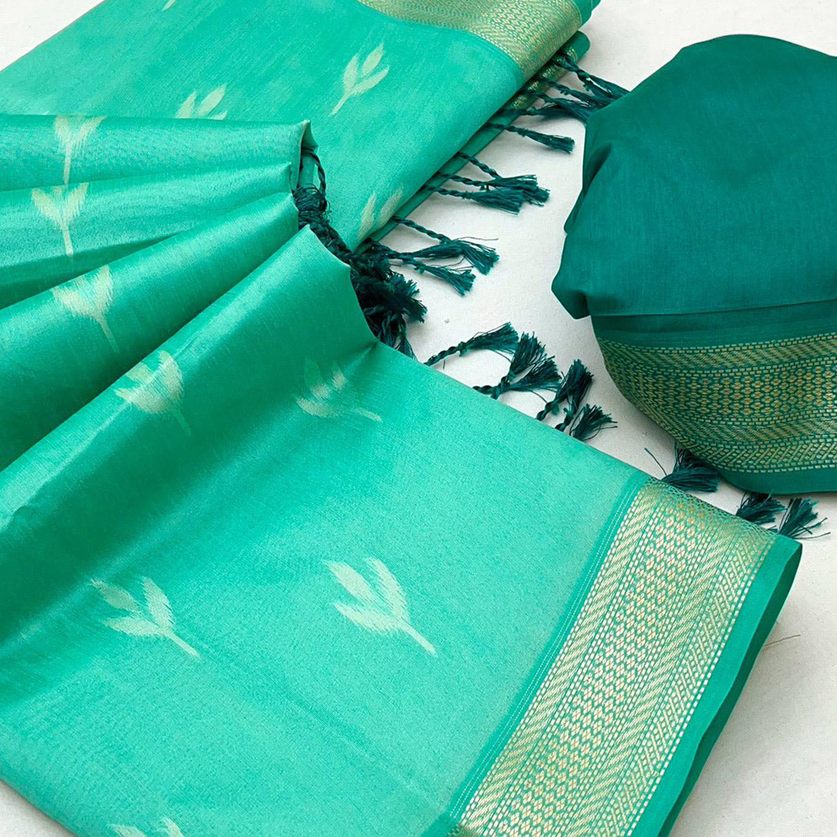 Turquoise Ikkat Style Rayon Silk Saree with Luxurious Zari Border and Delicate Tassels