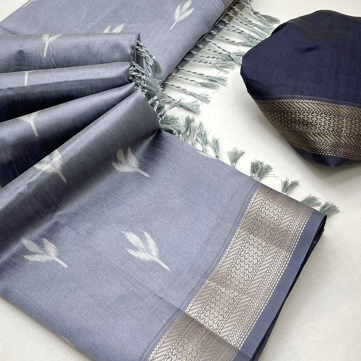 Grey Ikkat Style Rayon Silk Saree with Luxurious Zari Border and Delicate Tassels