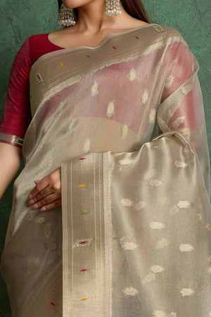 Graceful Beige Floral Woven Tissue Saree Adorned With Shimmering Jarkan Work & Tassel Pallu