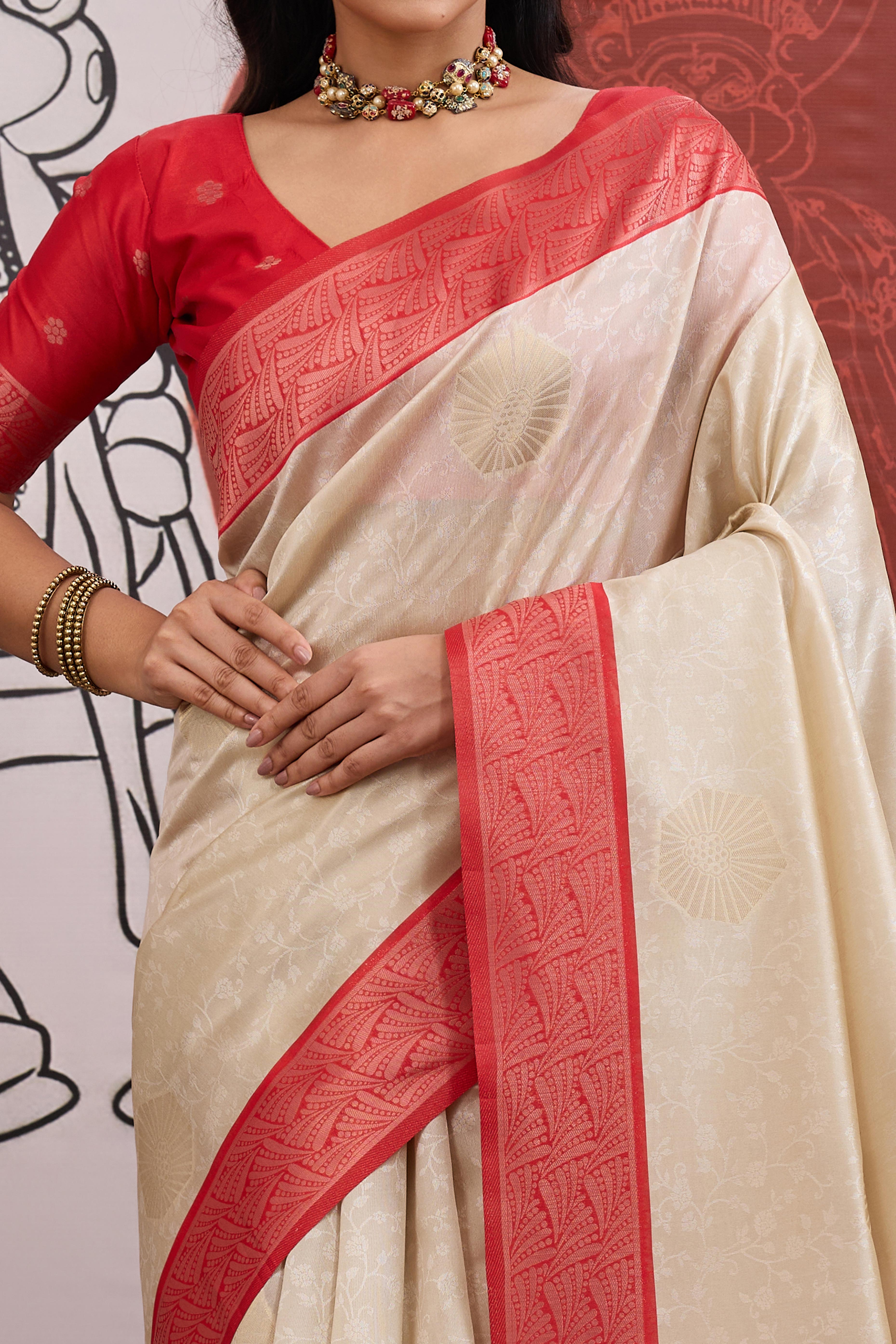 Graceful Cream & Red Zari Weaving Silk Saree Highlighted By Decorative Tassel Pallu