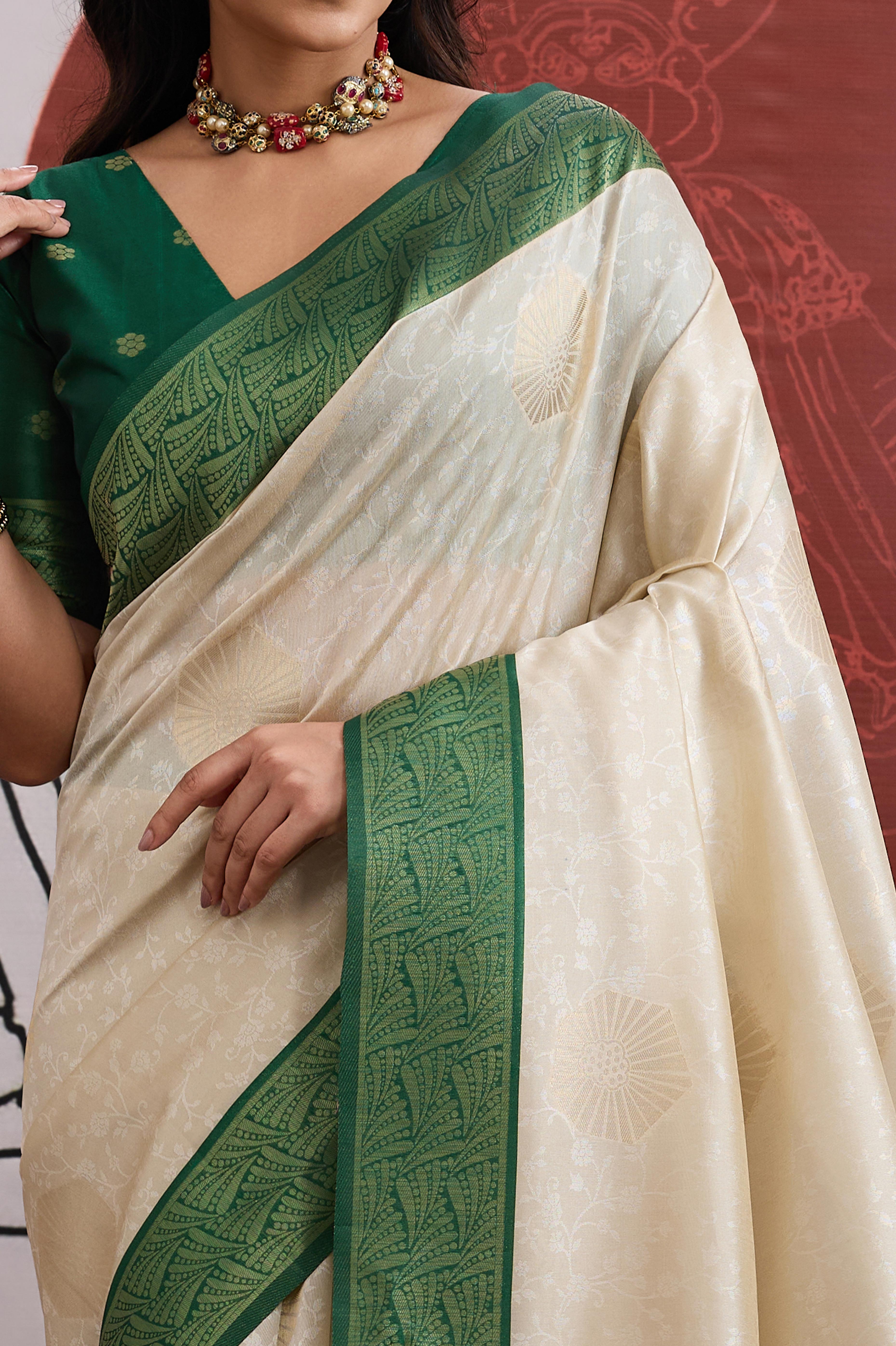 Graceful Cream & Green Zari Weaving Silk Saree Highlighted By Decorative Tassel Pallu