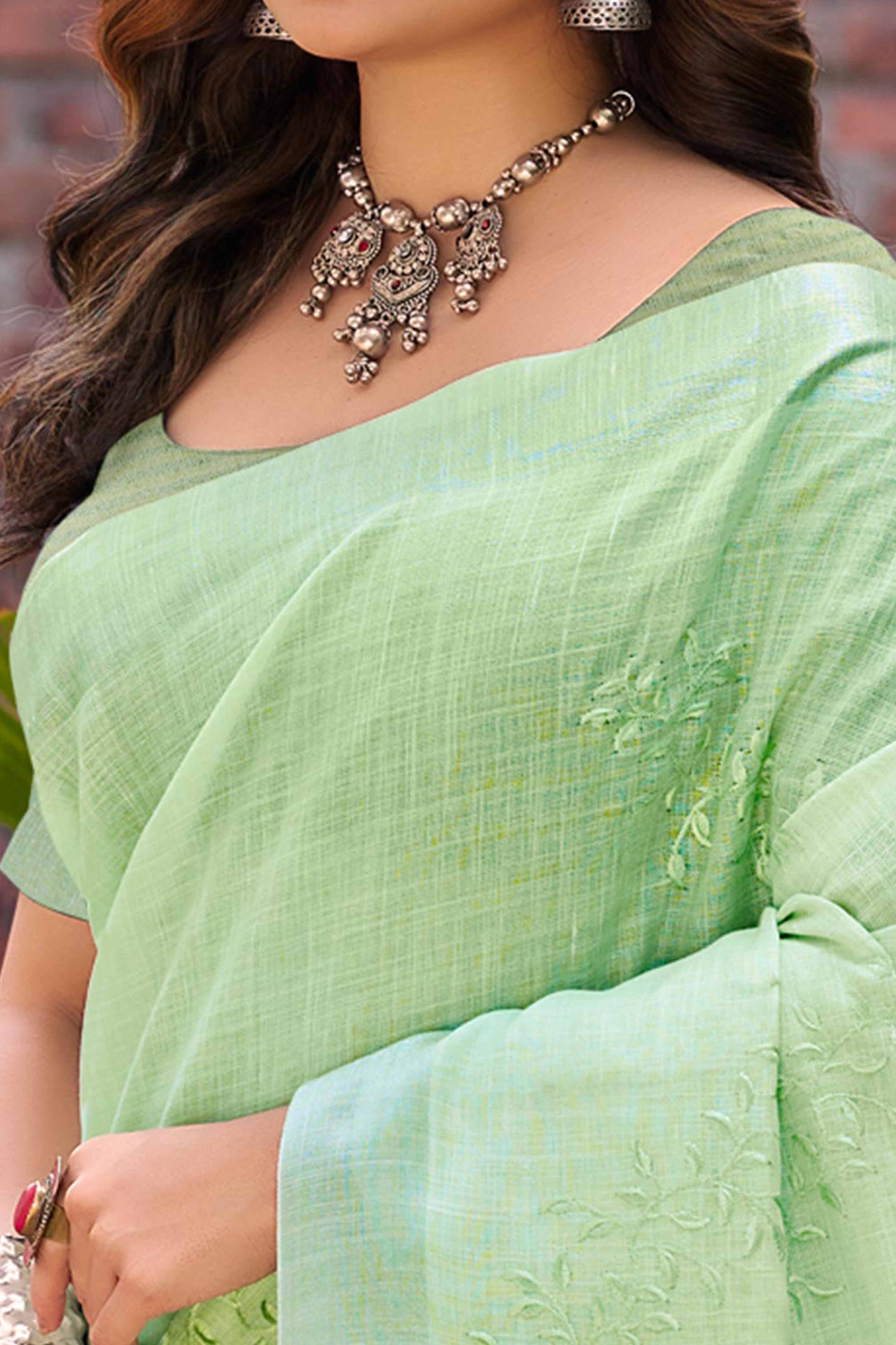 Elegant Green Linen Saree Featuring Intricate Woven & Embroidered Patterns