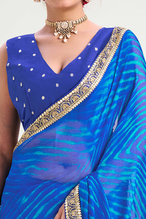 Blue Striped Printed Chiffon Saree Enhanced With Sparkling Sequins Embroidered Border Work