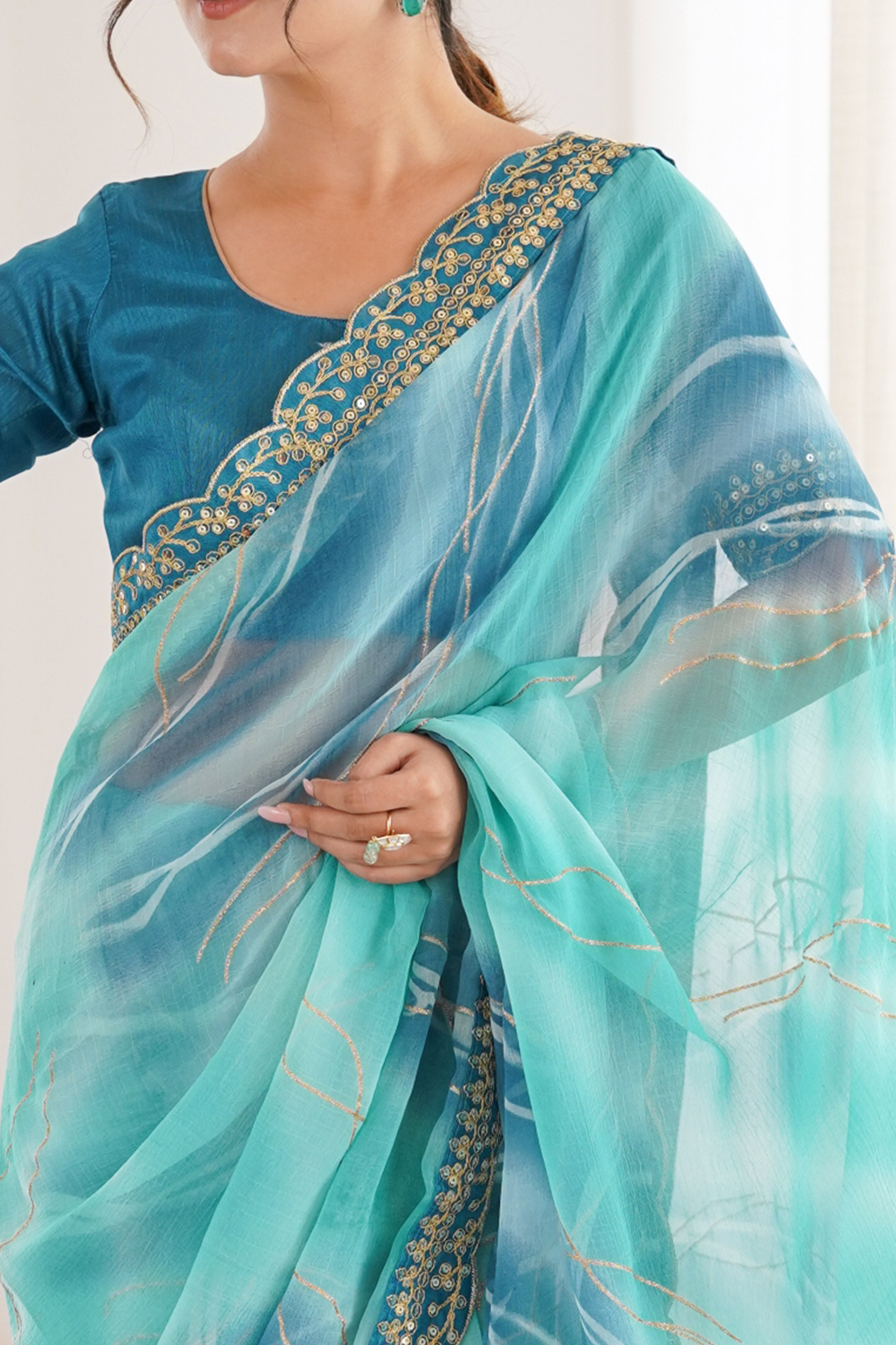Graceful Blue Foil Print Georgette Saree Featuring A Luxurious Cording Sequins Embroidered Border
