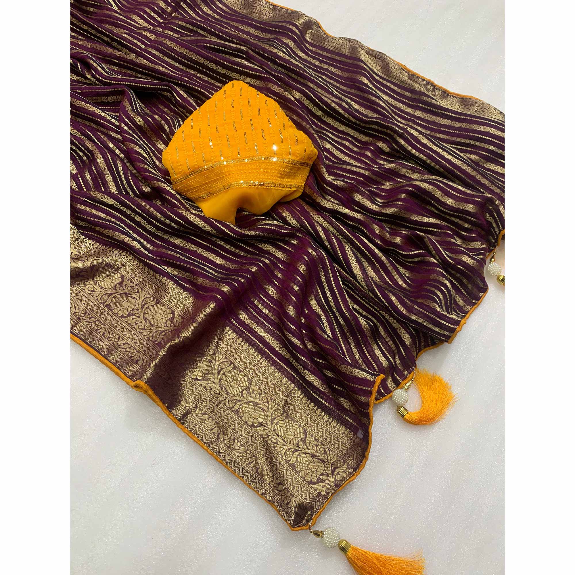 Wine Woven Georgette Saree With Tassels