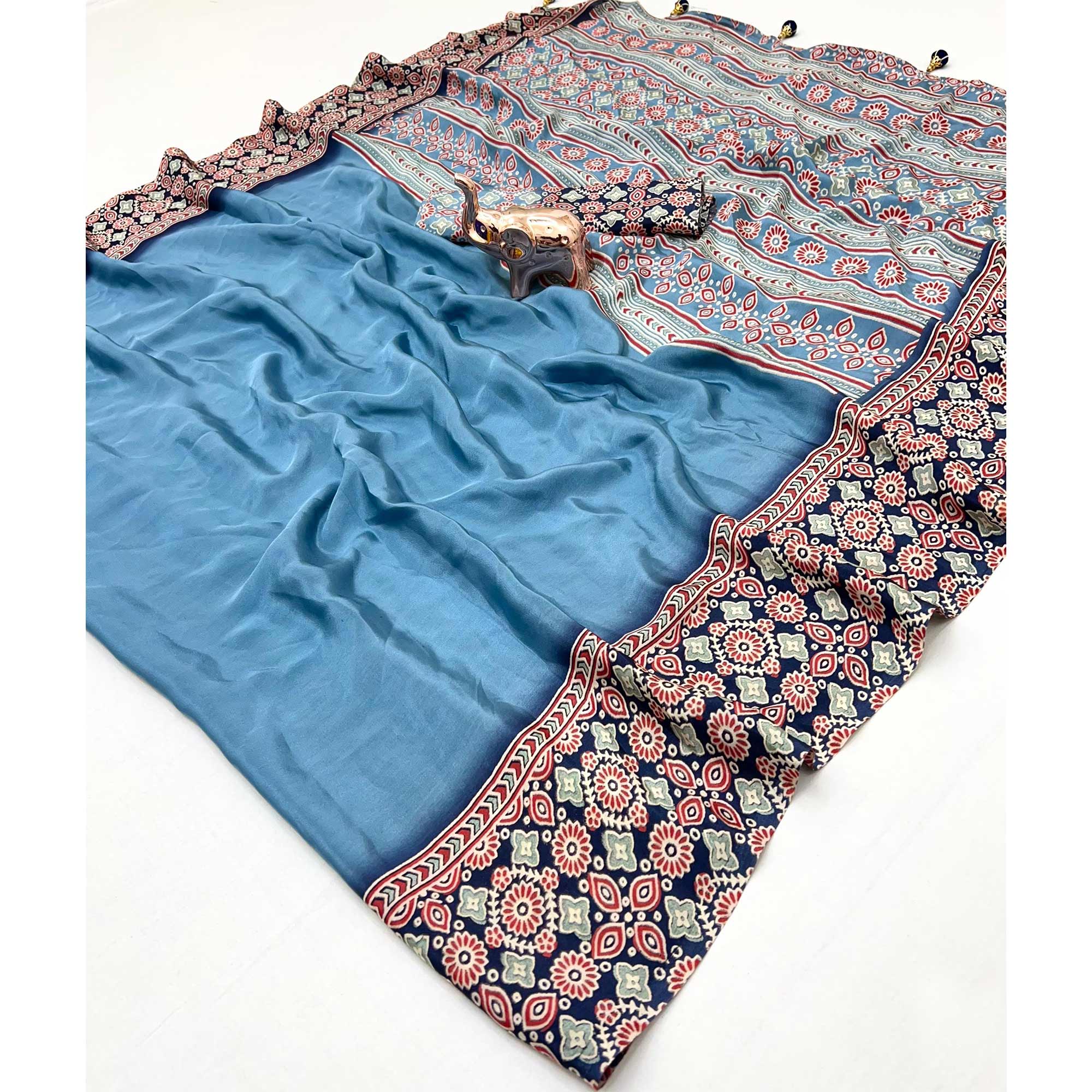 Blue Solid Satin Saree Featuring Bold Ajrakh Print and Tassel Accented Pallu