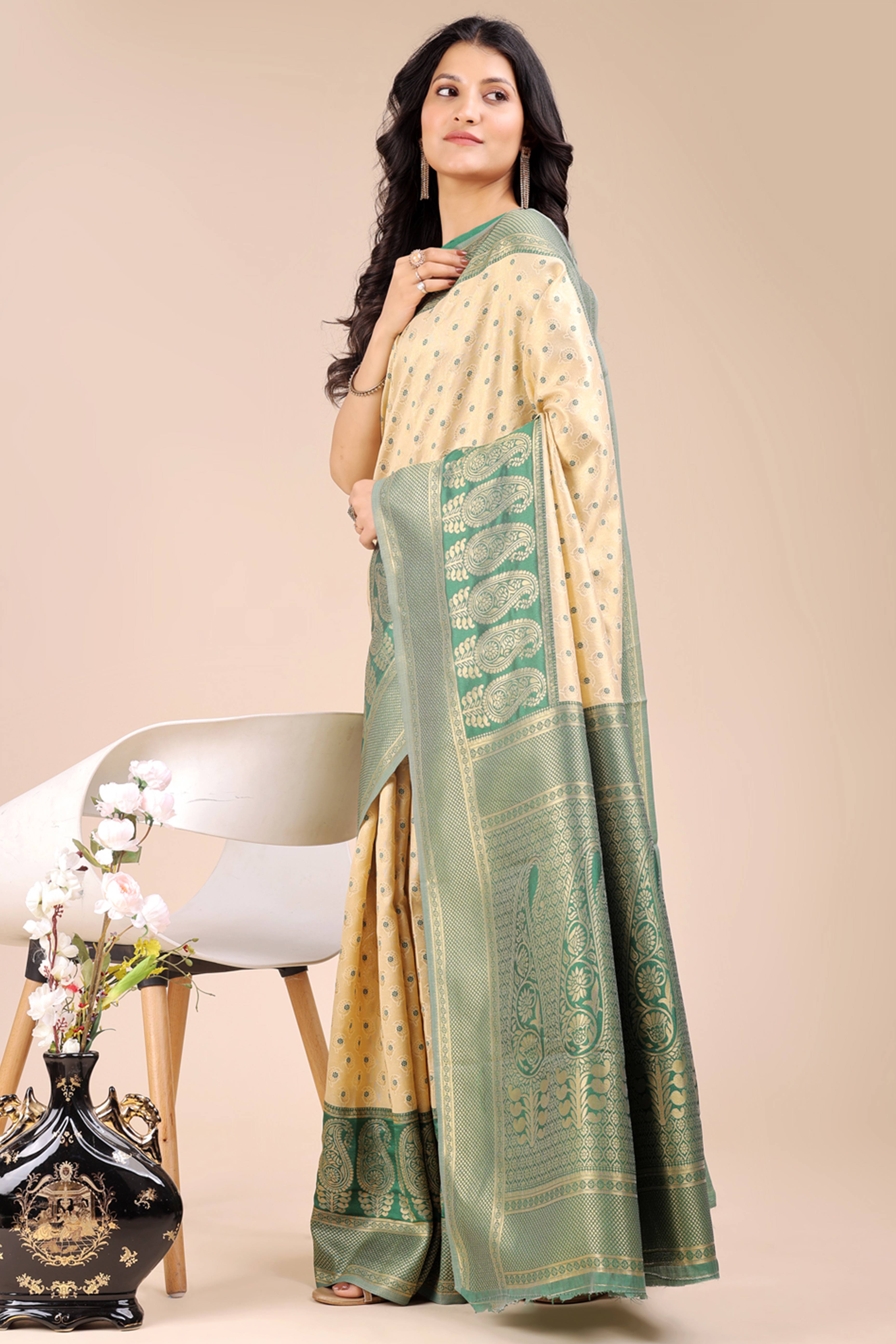 Cream Banarasi Silk Saree Featuring Lustrous Green Floral Zari Weaving and a Rich Contrast Border