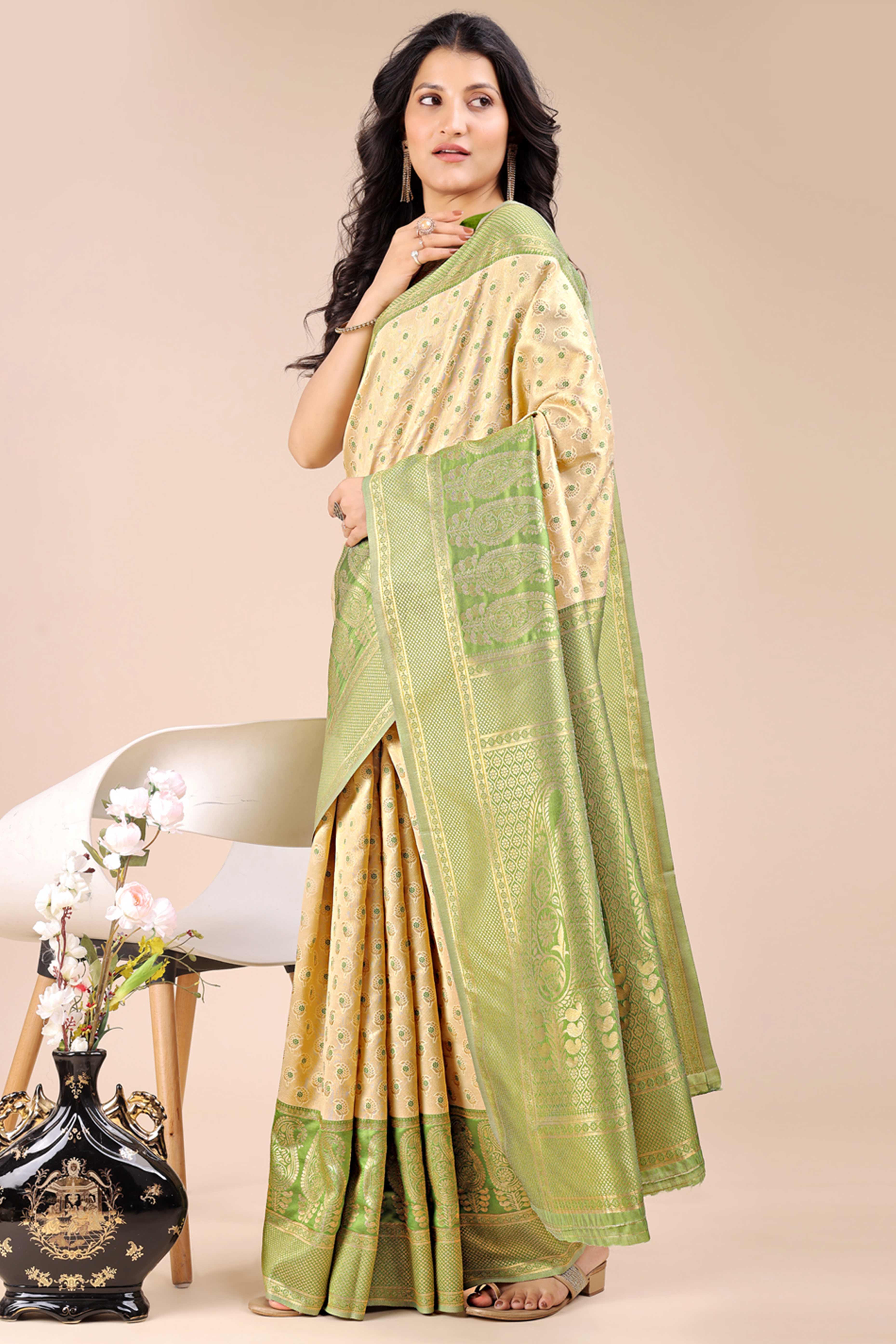 Cream Banarasi Silk Saree Featuring Lustrous Light Green Floral Zari Weaving and a Rich Contrast Border