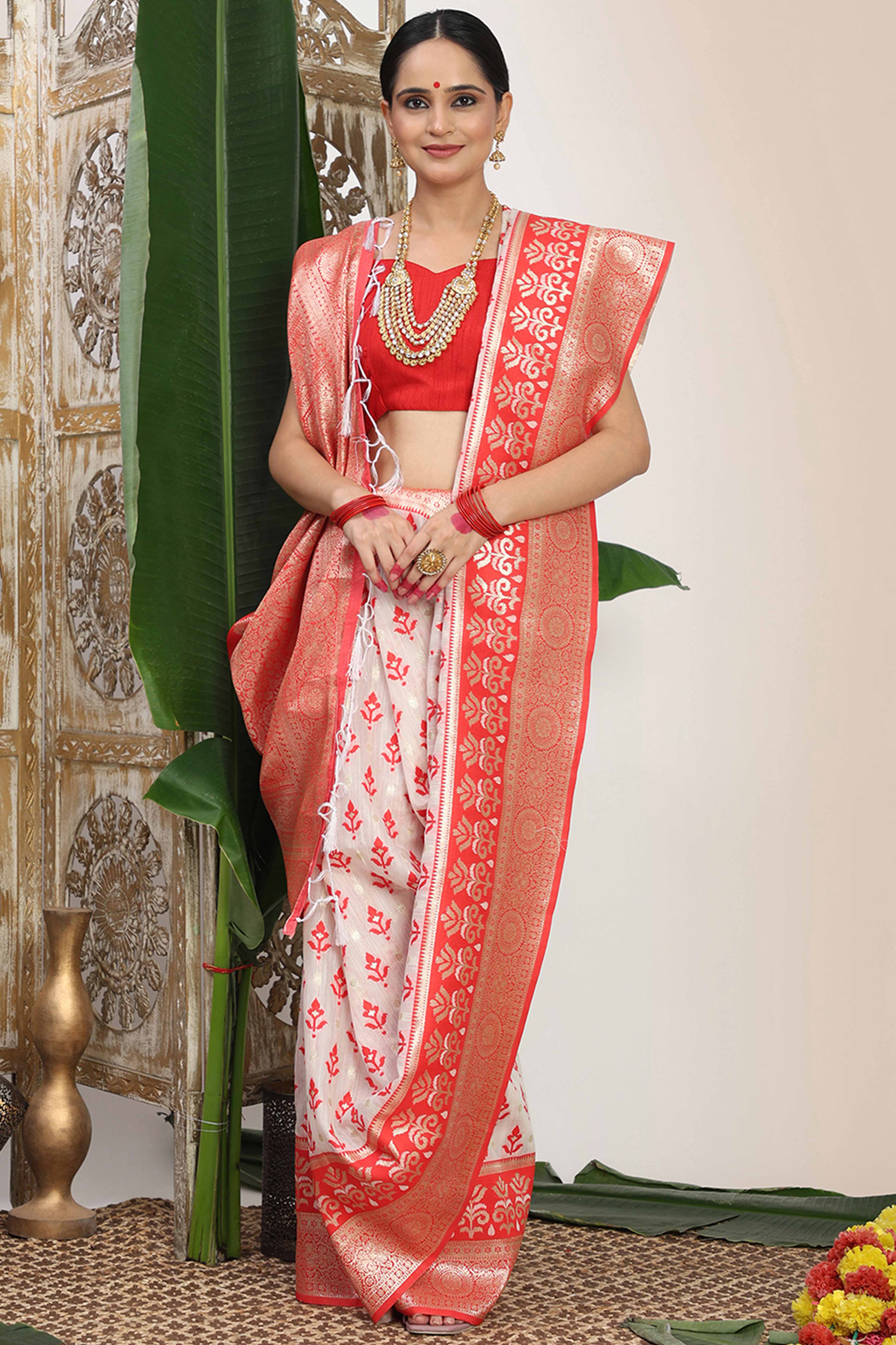 White & Red Linen Cotton Saree Showcasing Elegant Zari Weaving And A Tassel-Embellished Pallu
