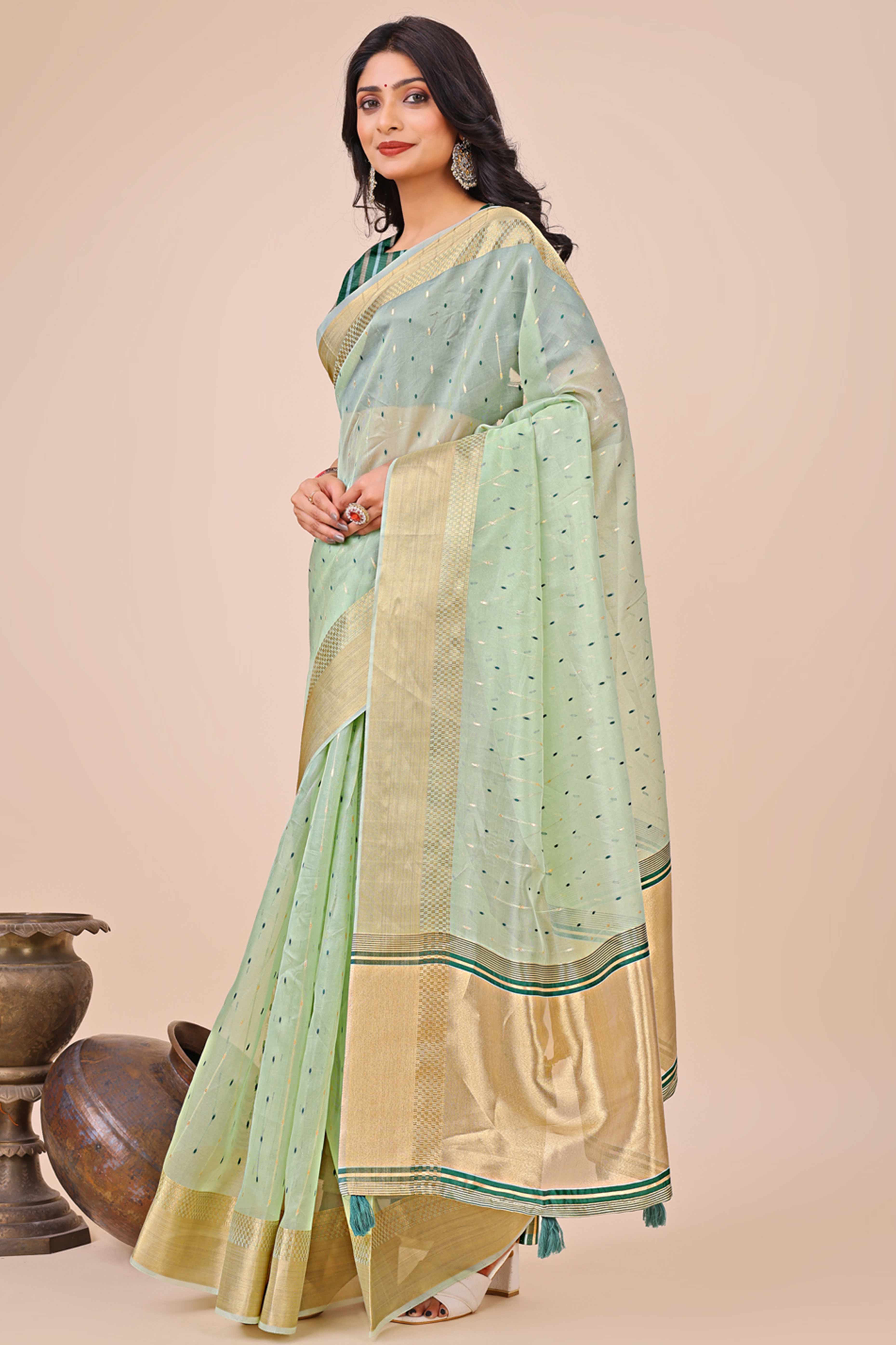 Sea Green Organza Saree Adorned With Fine Zari Weaving & Stylish Tassel Edging