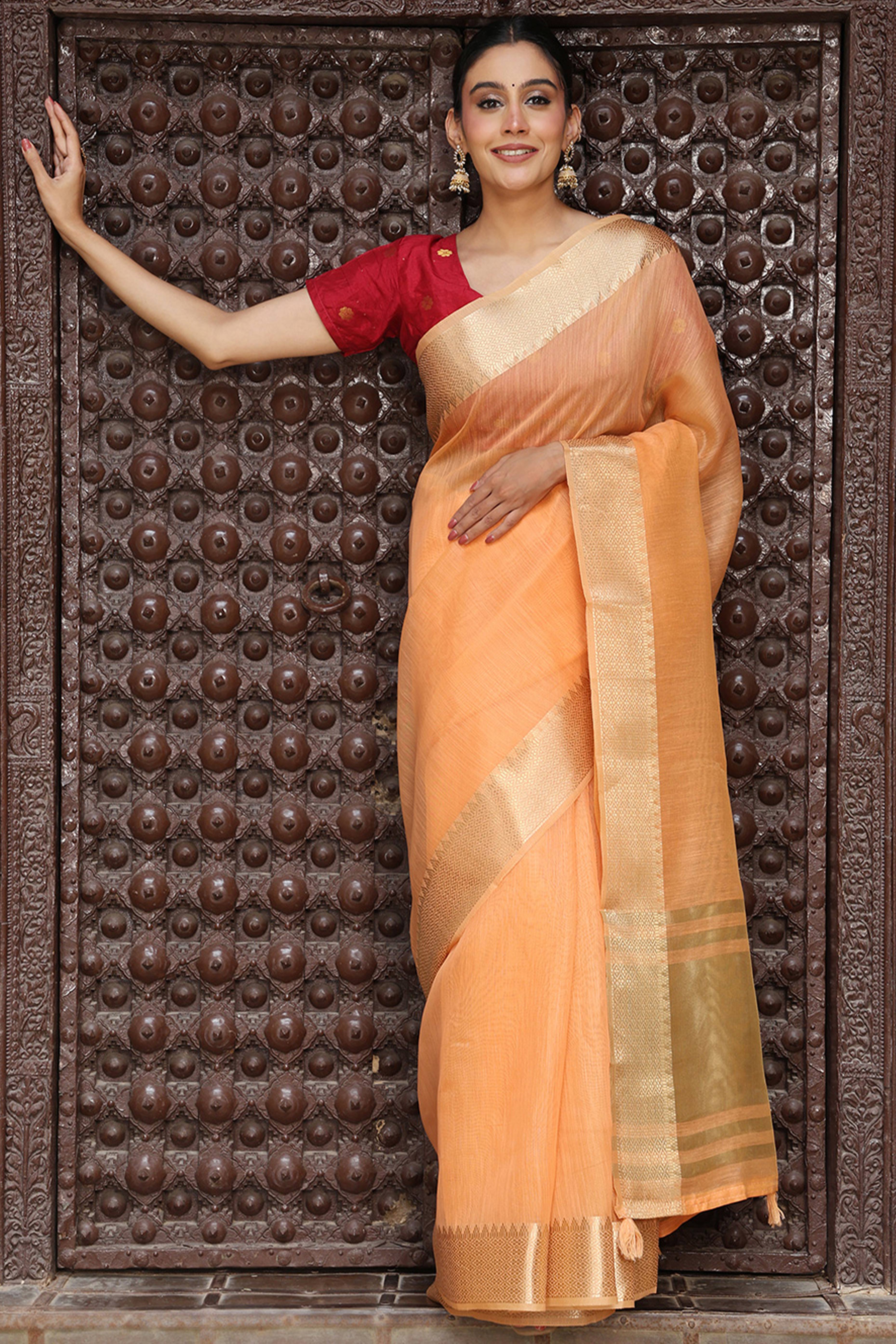 Trendy Orange Cotton Blend Saree Showcasing Elegant Zari Weaving & Tassel Border Pallu