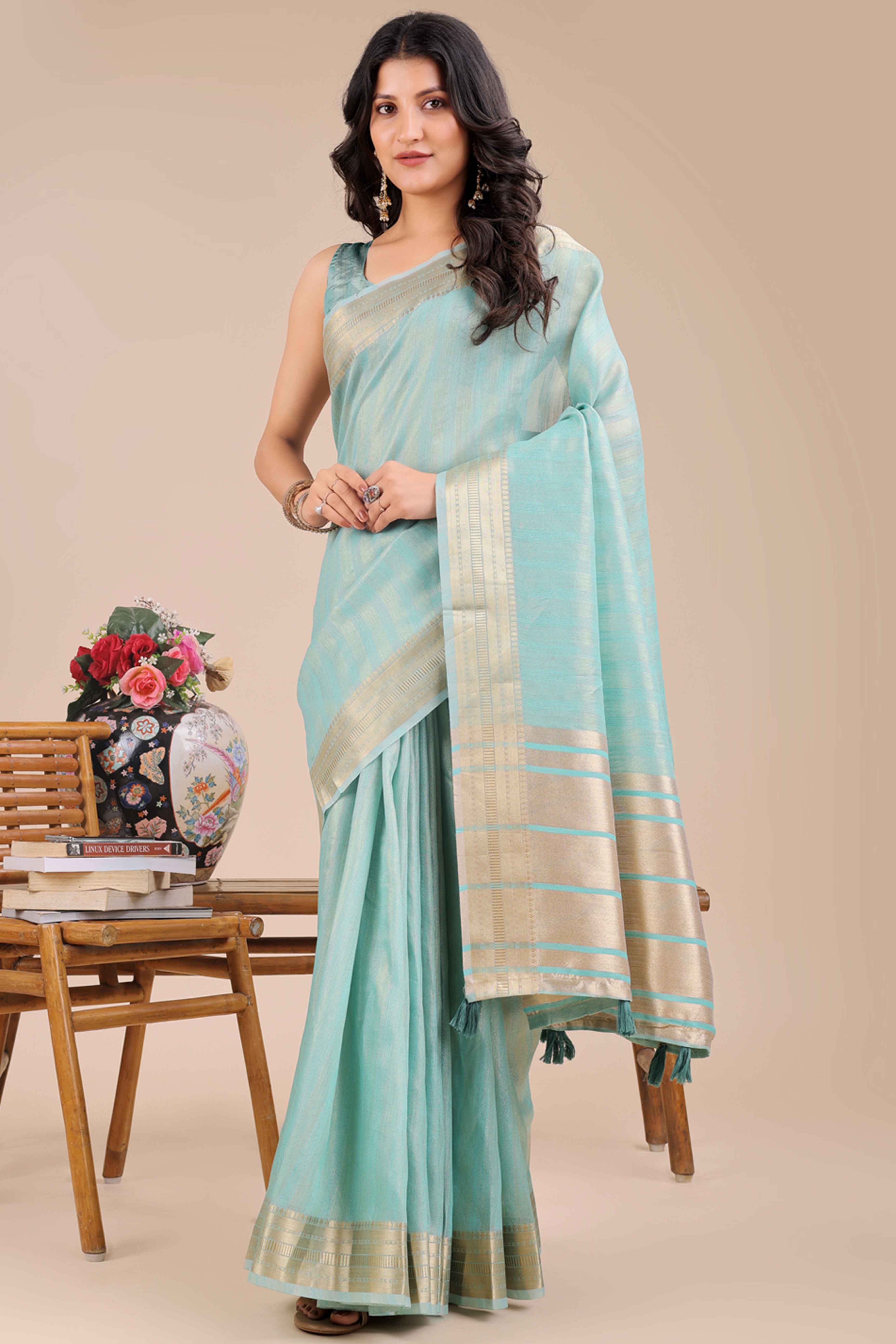 Light Turquoise Organza Saree With Intricate Weave & Elegant Tassel Accents