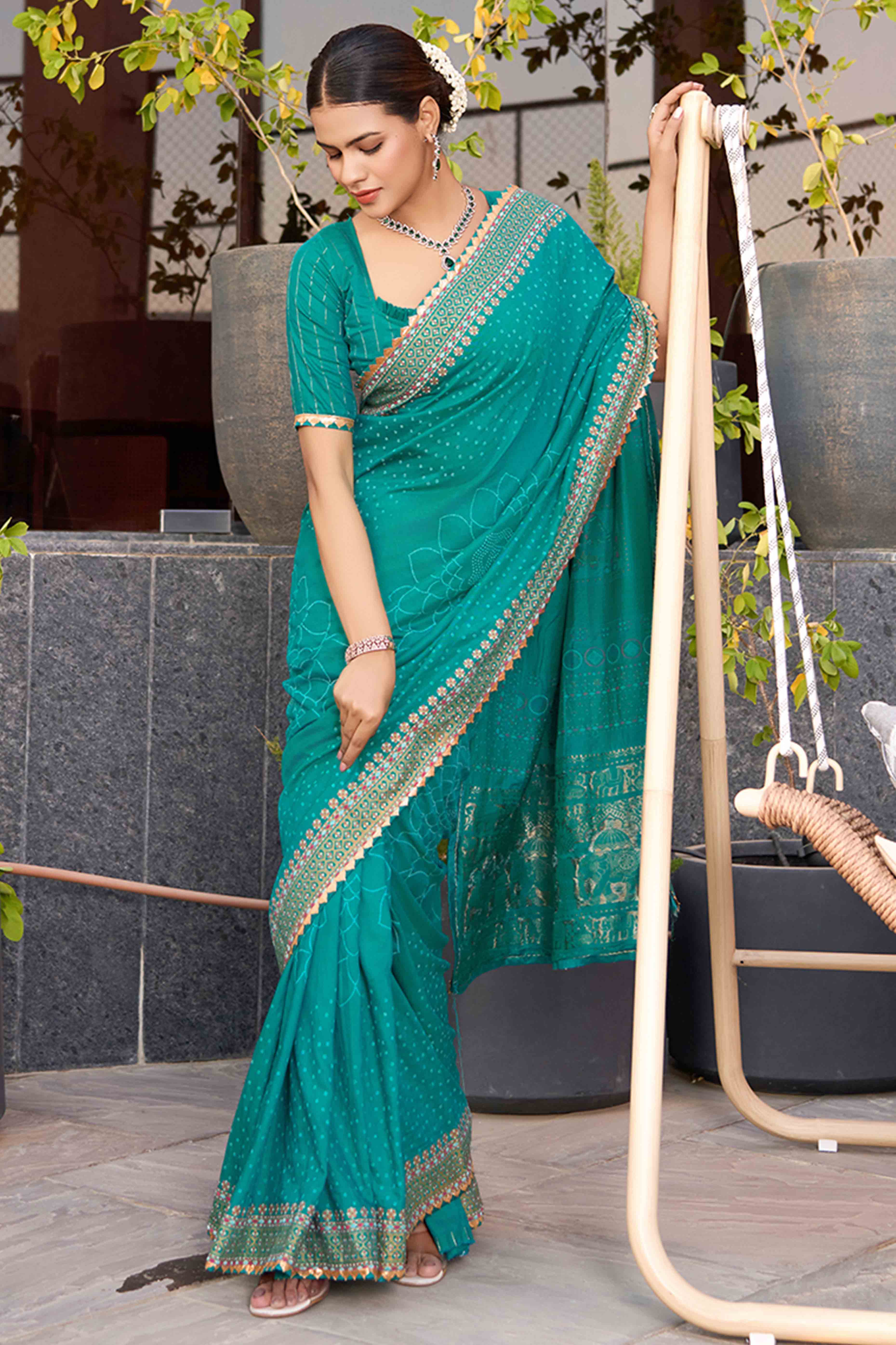 Drape Yourself In The Charm Of Rama Blue Bandhani Foil Printed Cotton Silk Sarree With Lace Border