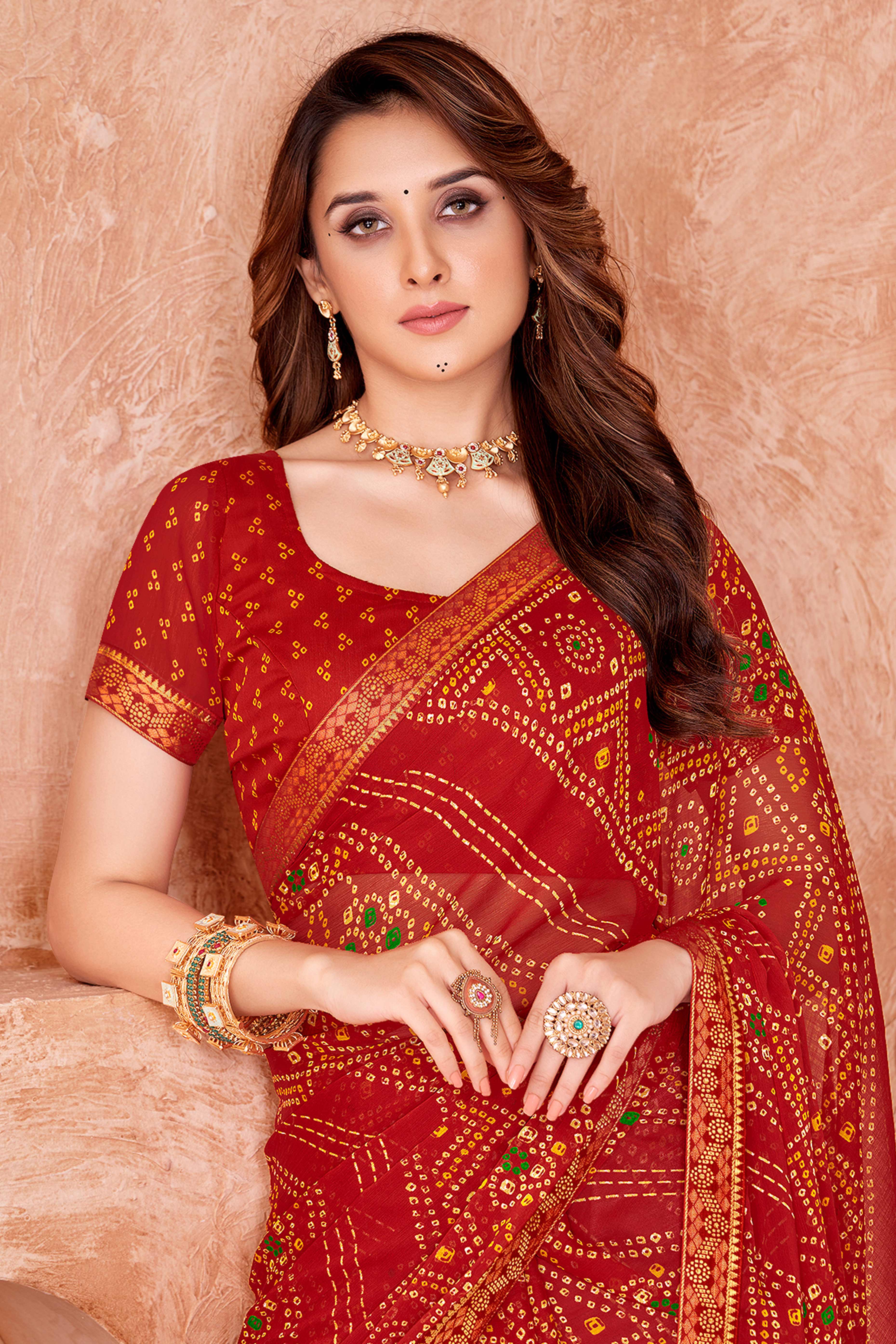 Red Chiffon Saree Featuring Traditional Bandhani Prints & A Graceful Lace Edge