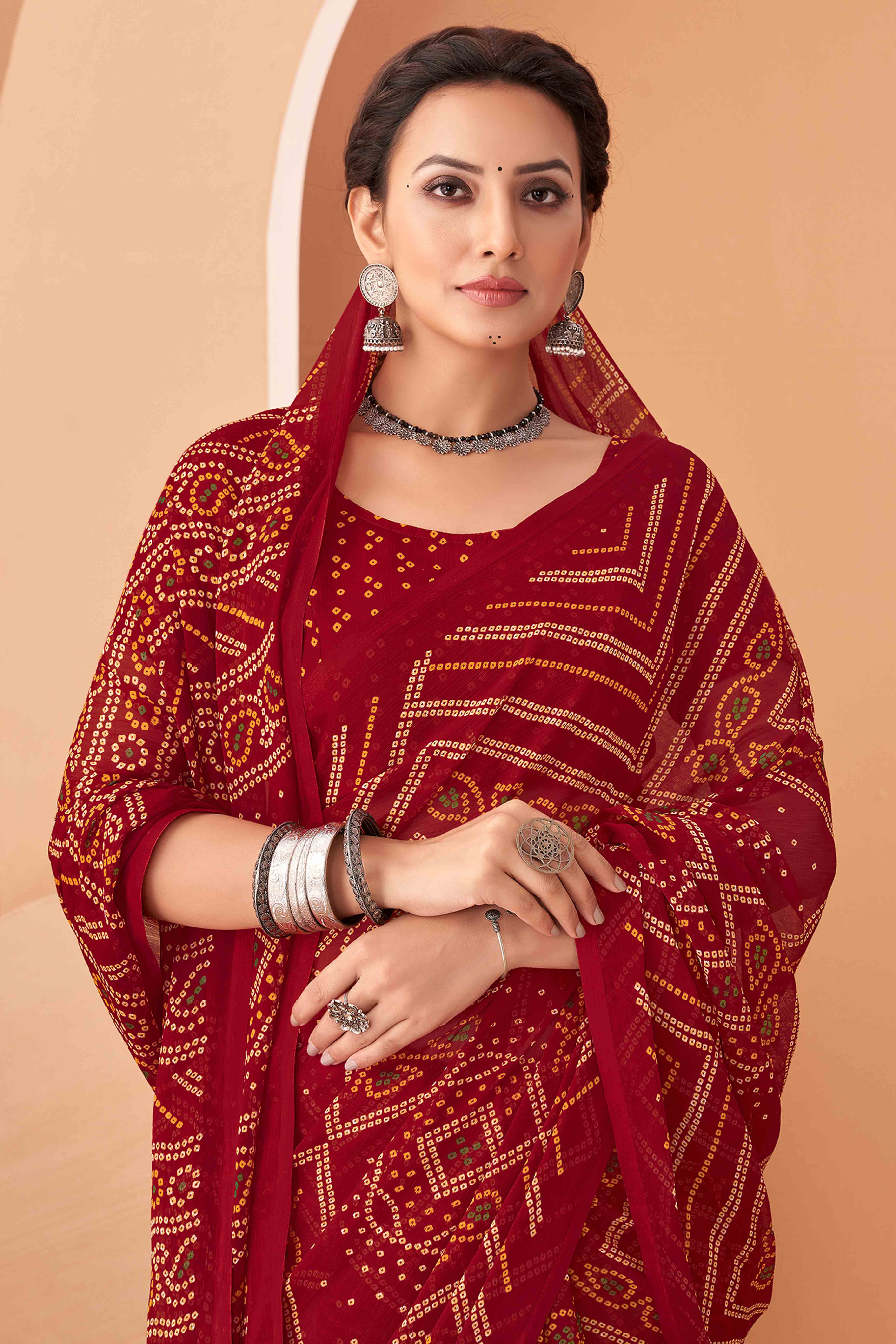 Maroon Bandhani Printed Chiffon Saree Accented With Intricate Lace Border Work
