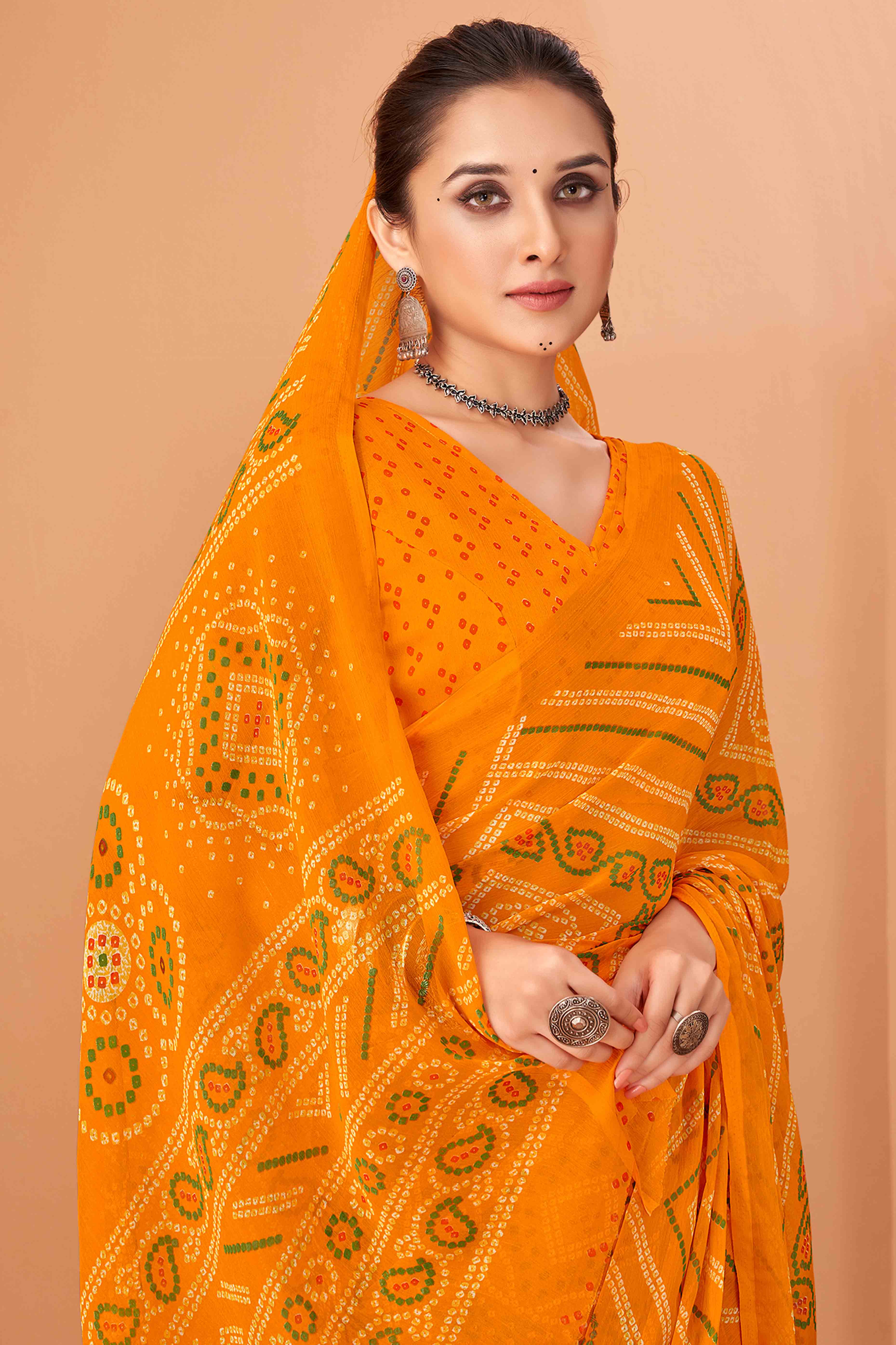 Mustard Bandhani Printed Chiffon Saree Accented With Intricate Lace Border Work