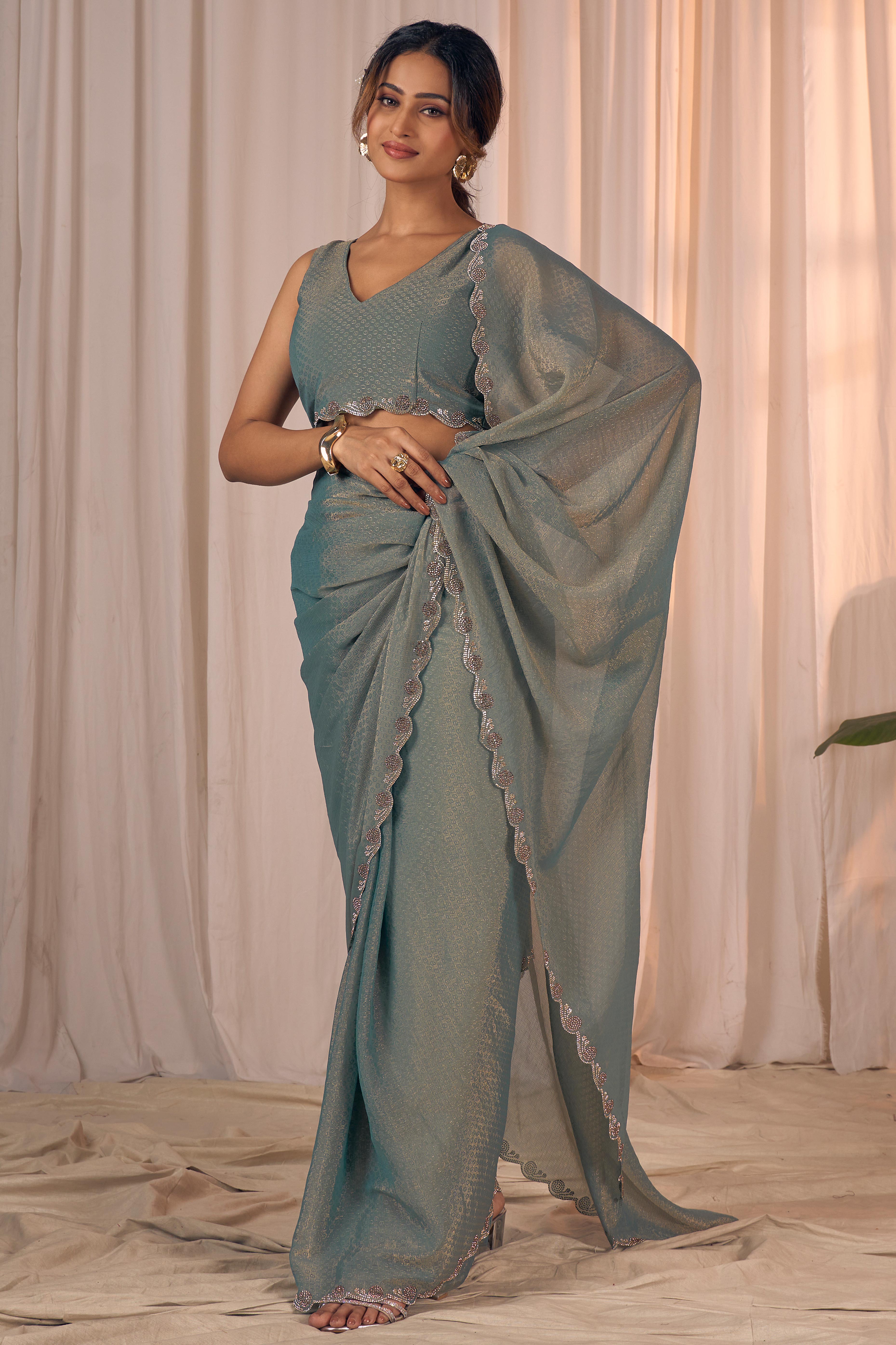 Designer Sage Green Georgette Saree Adorned With An Elegant Zarkan Cutwork Border