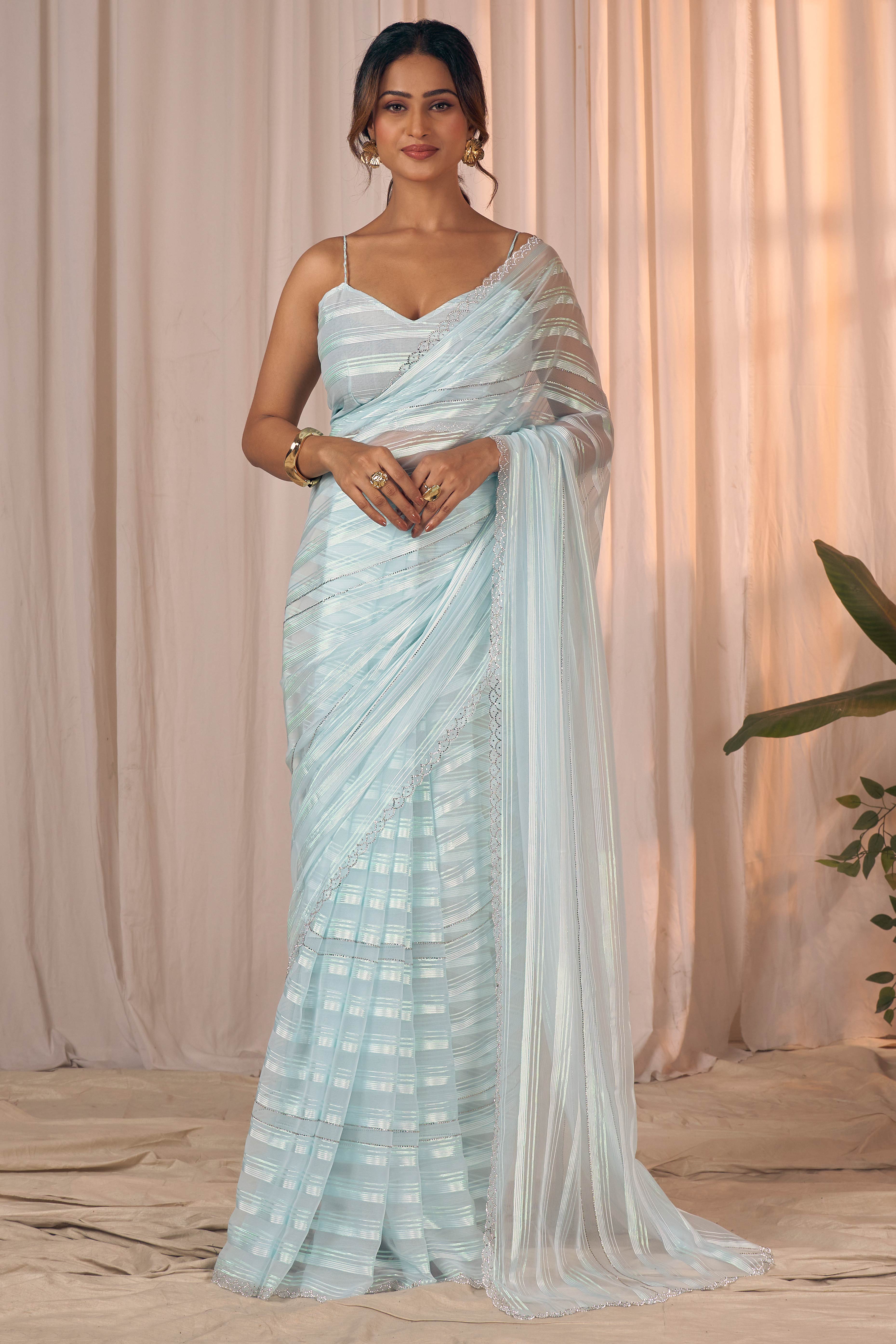 Light Turquoise Striped Georgette Saree With Sparkling Zarkan Work & An Elegant Cutwork Border