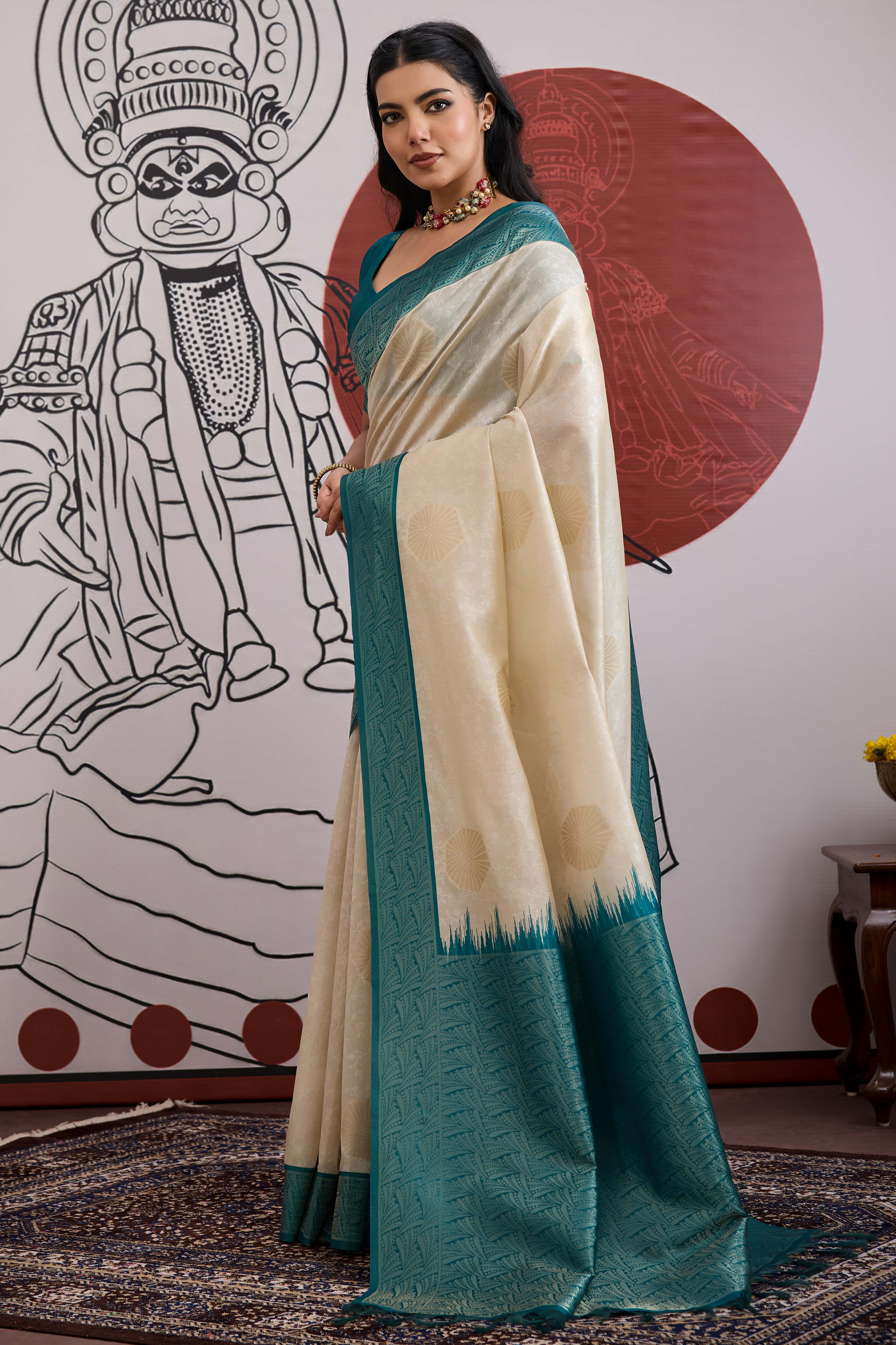 Graceful Cream & Teal Zari Weaving Silk Saree Highlighted By Decorative Tassel Pallu