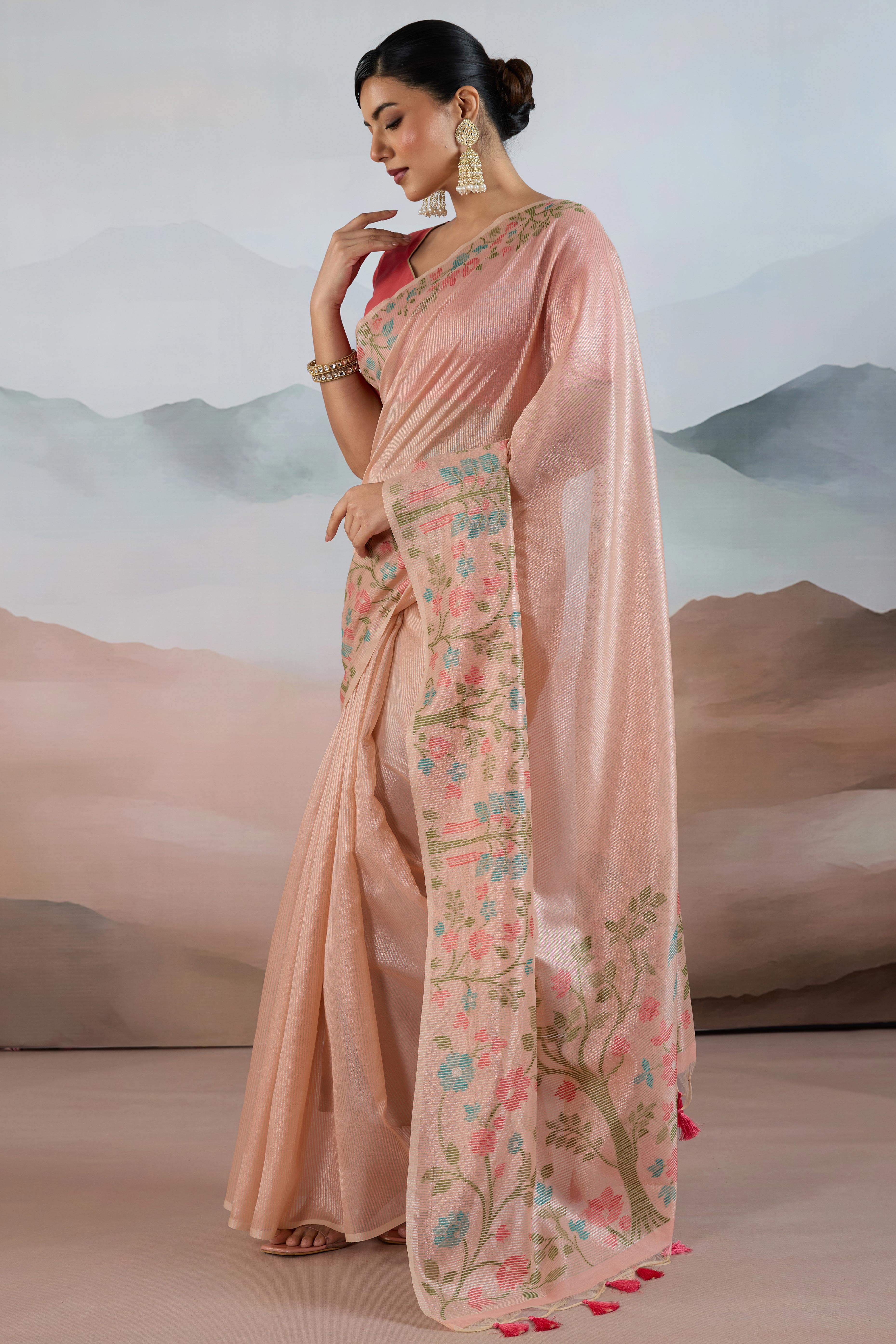 Peach Tissue Silk Saree Showcasing Floral & Striped Weaving With Tassel Adornment