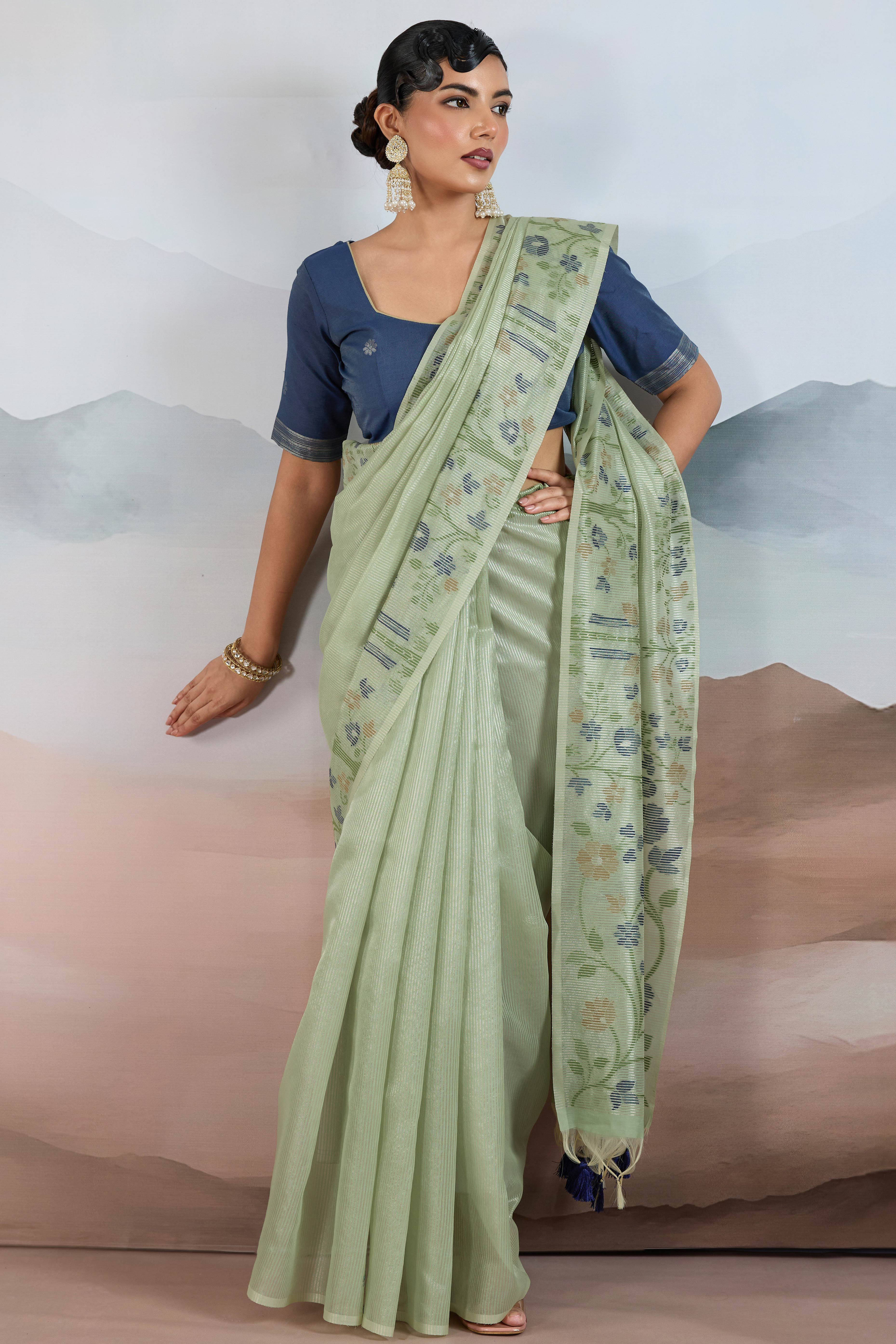 Green Tissue Silk Saree Showcasing Floral & Striped Weaving With Tassel Adornment