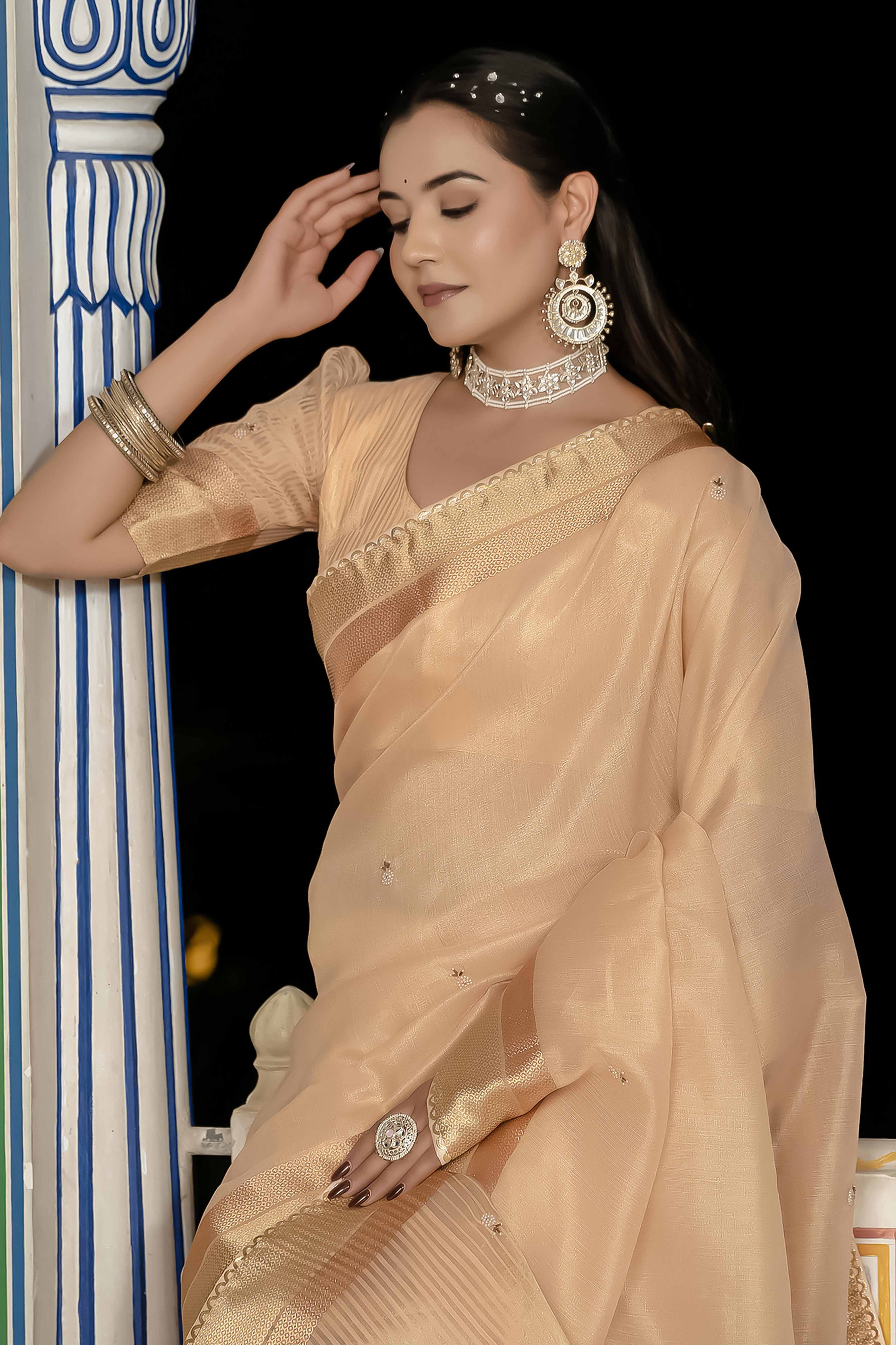 Peachy Beige Tissue Linen Saree Featuring Intricate Zari and Beadwork