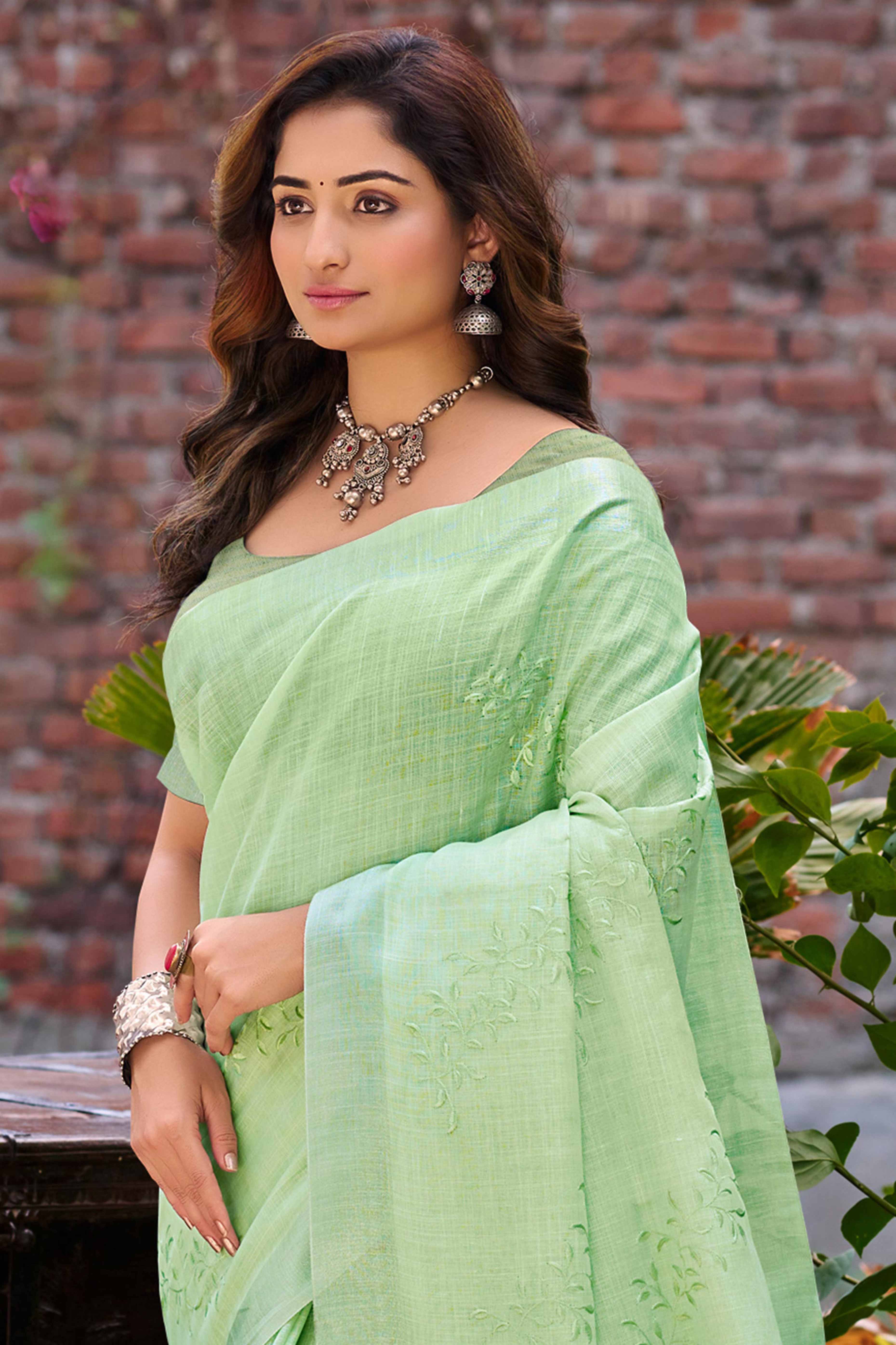 Elegant Green Linen Saree Featuring Intricate Woven & Embroidered Patterns