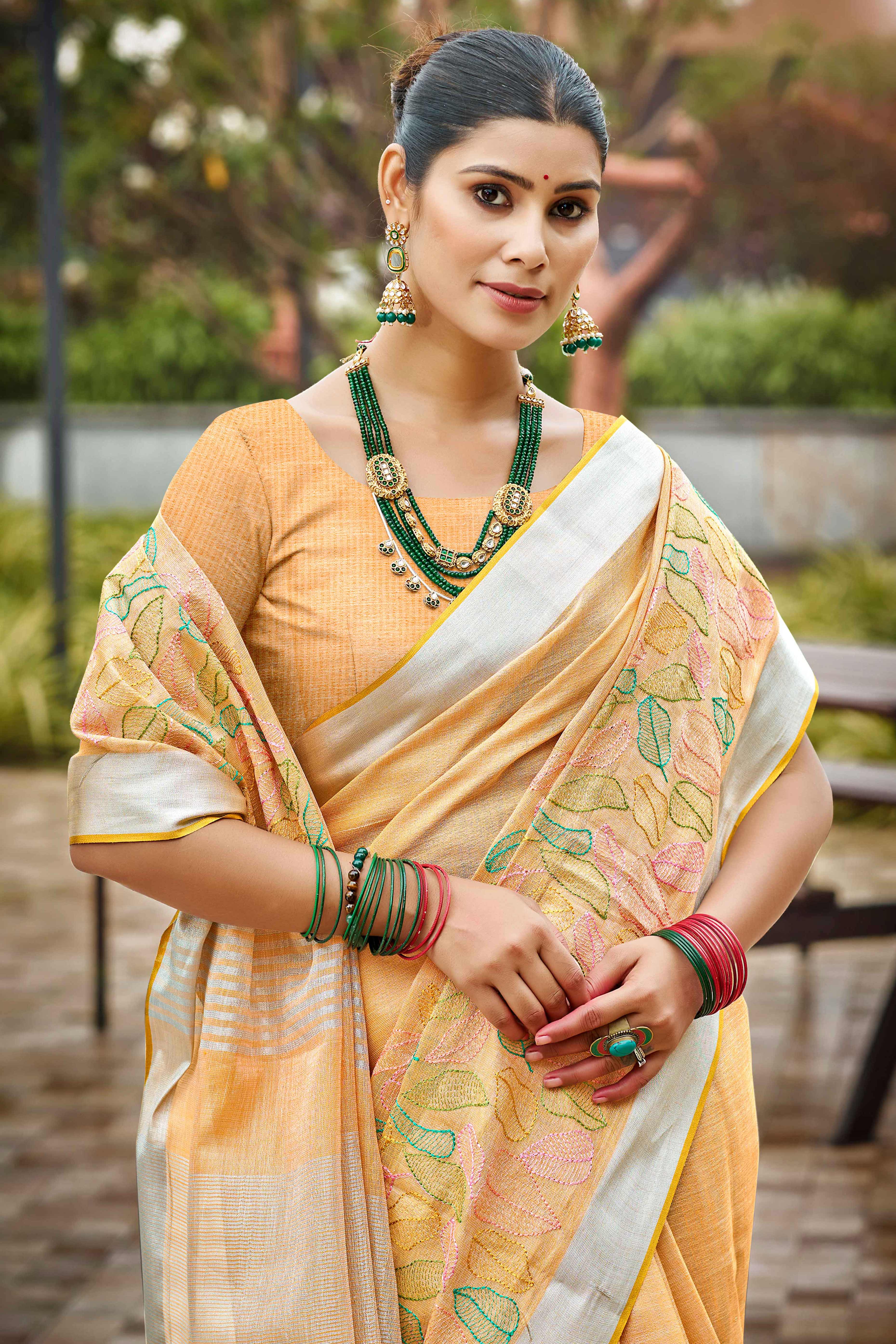 Classic Light Orange Leaf Pattern Thread Embroidery Work Linen Saree With Tassel Pallu