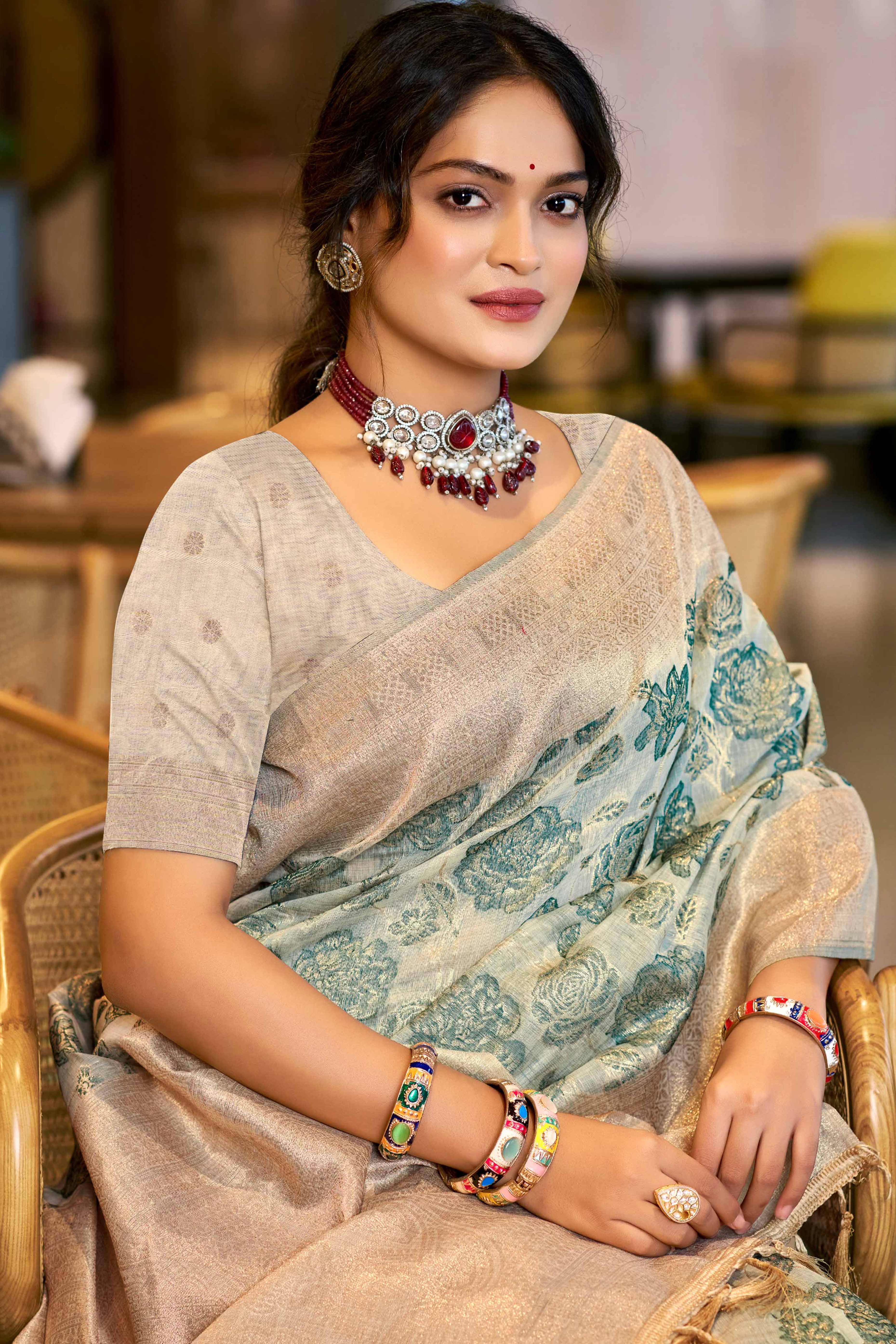 Teal Premium Cotton Silk Saree Highlighted With Floral Weaving Work & Tassel Pallu