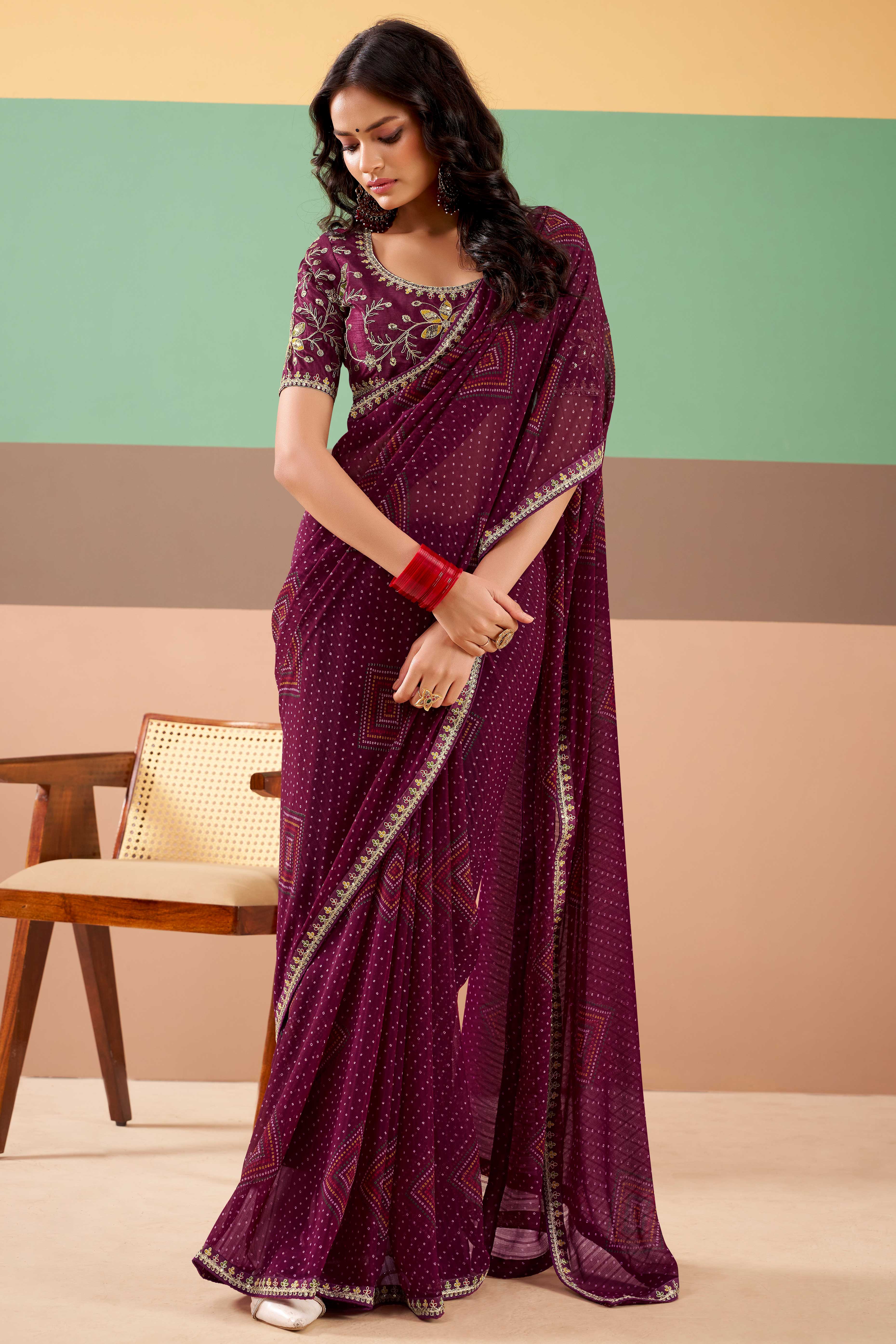 Charming Wine Bandhani Printed Georgette Saree Adorned With Intricate Cording Embroidered Border