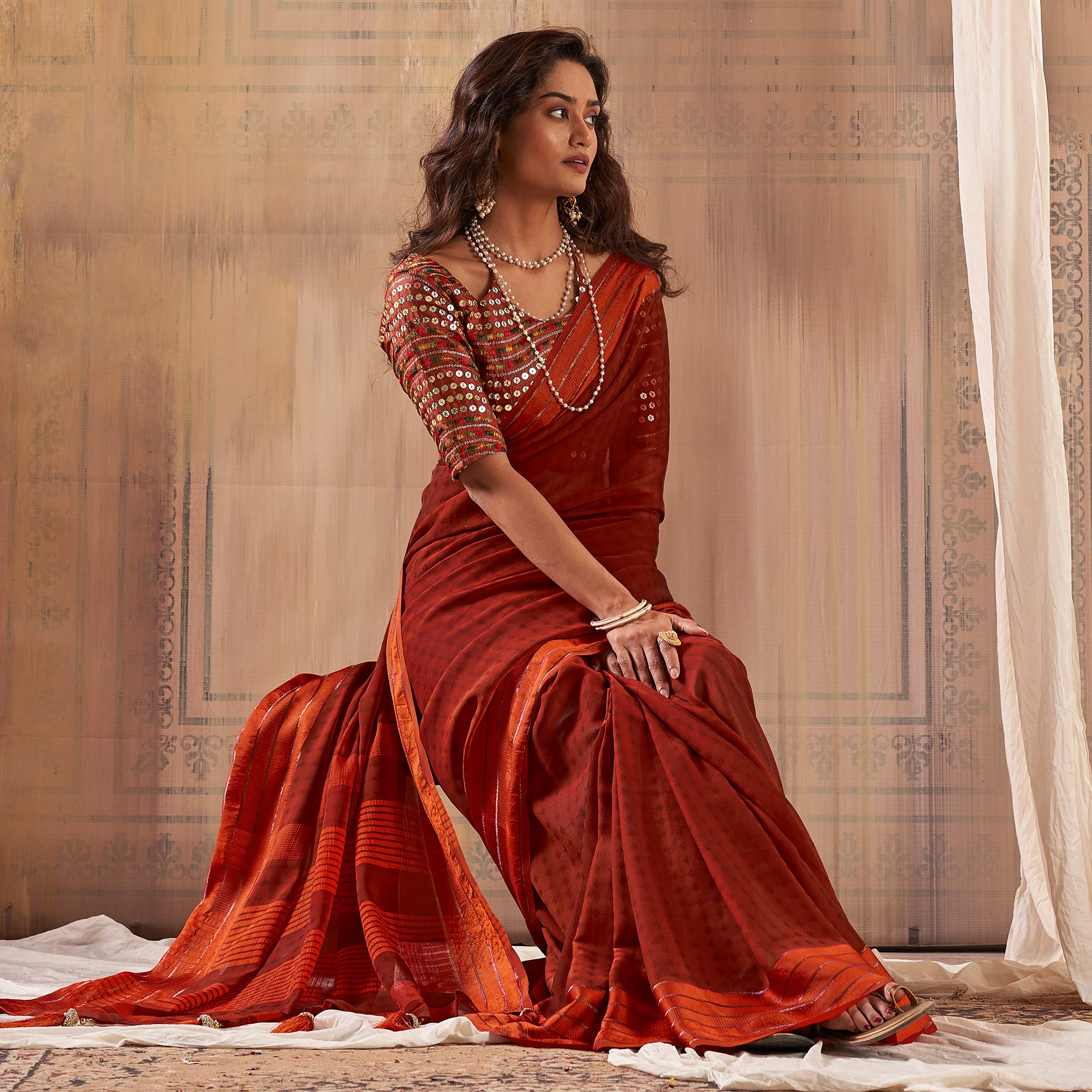 Rust Woven Georgette Saree With Tassels