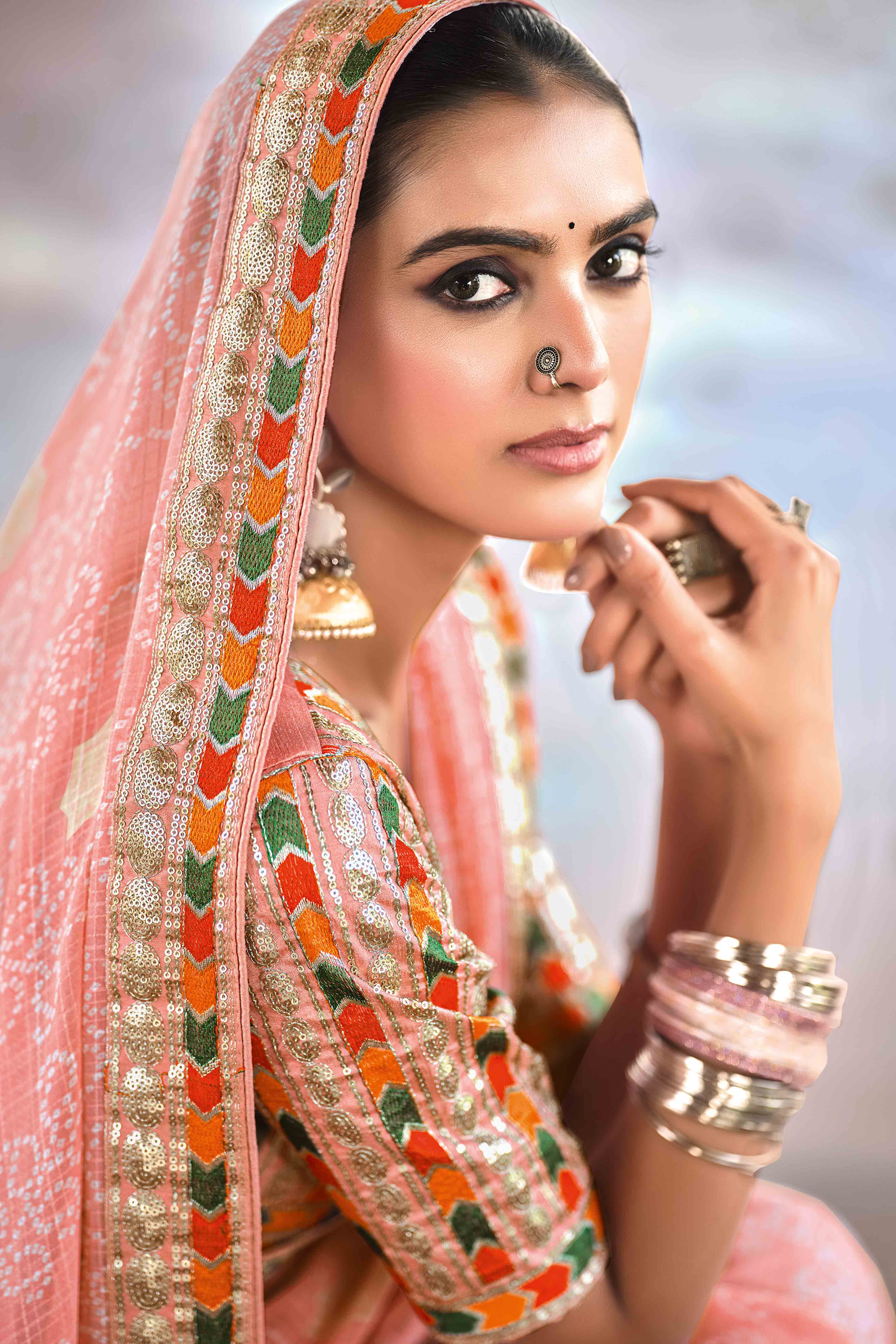 Peach Bandhani Printed Georgette Saree With Glittering Sequin Embroidered Border