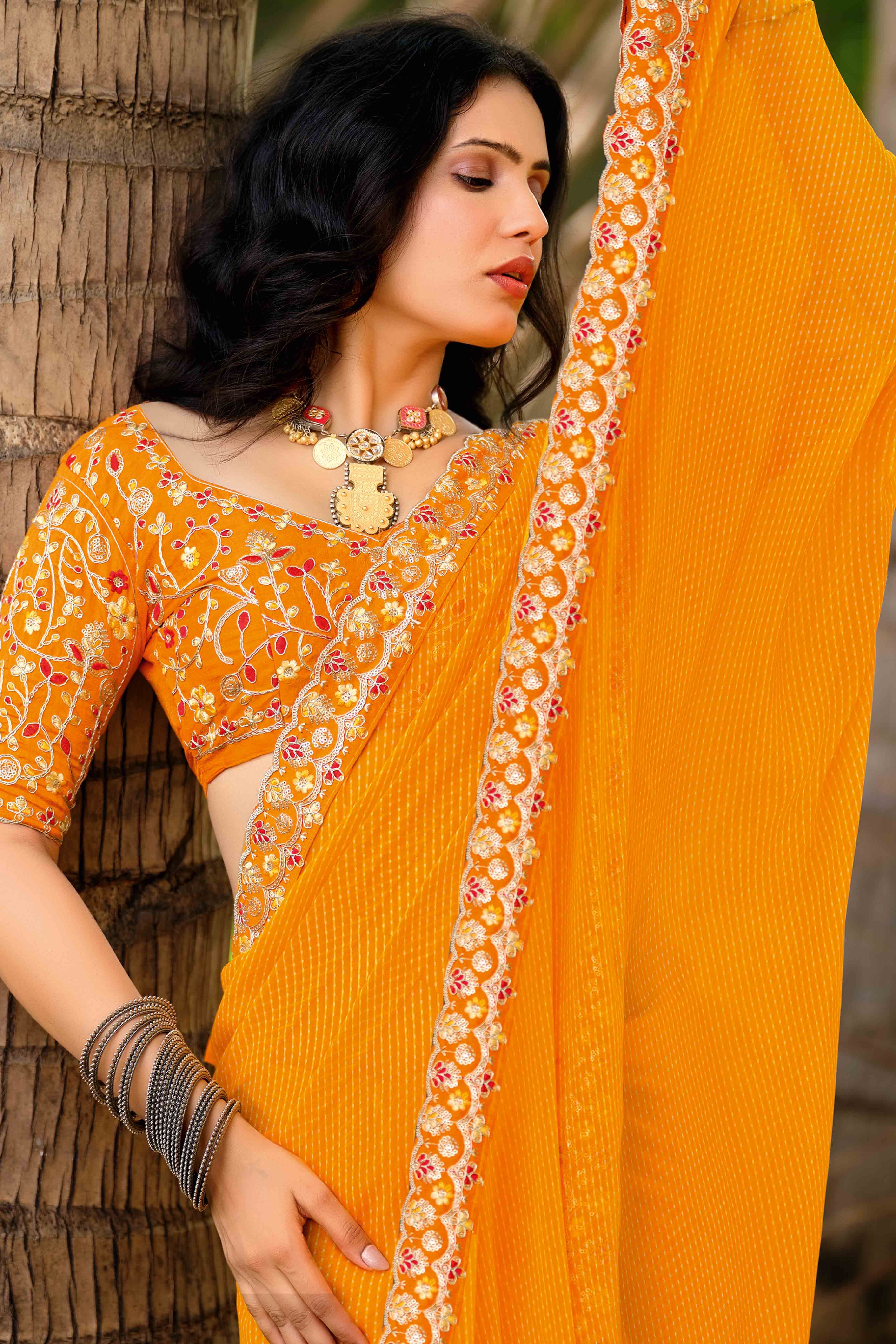 Bright Orange Striped Printed Georgette Saree With Shimmering Sequin Embroidered Border