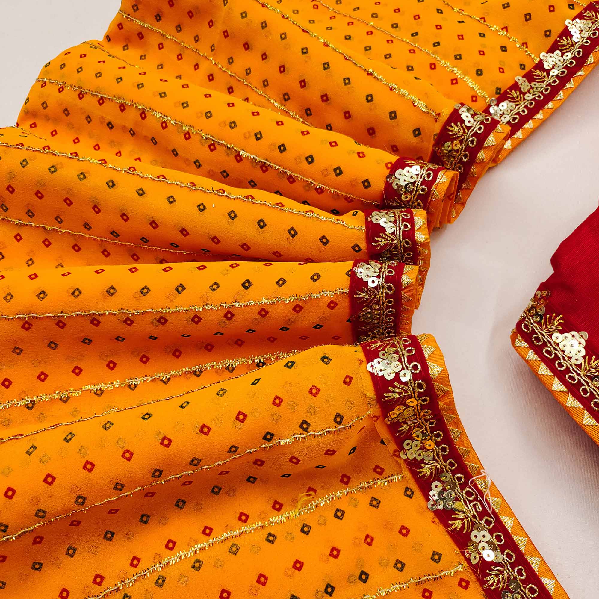 Charming Mustard Bandhani Printed Georgette Saree With Glittering Sequins & Zari Border
