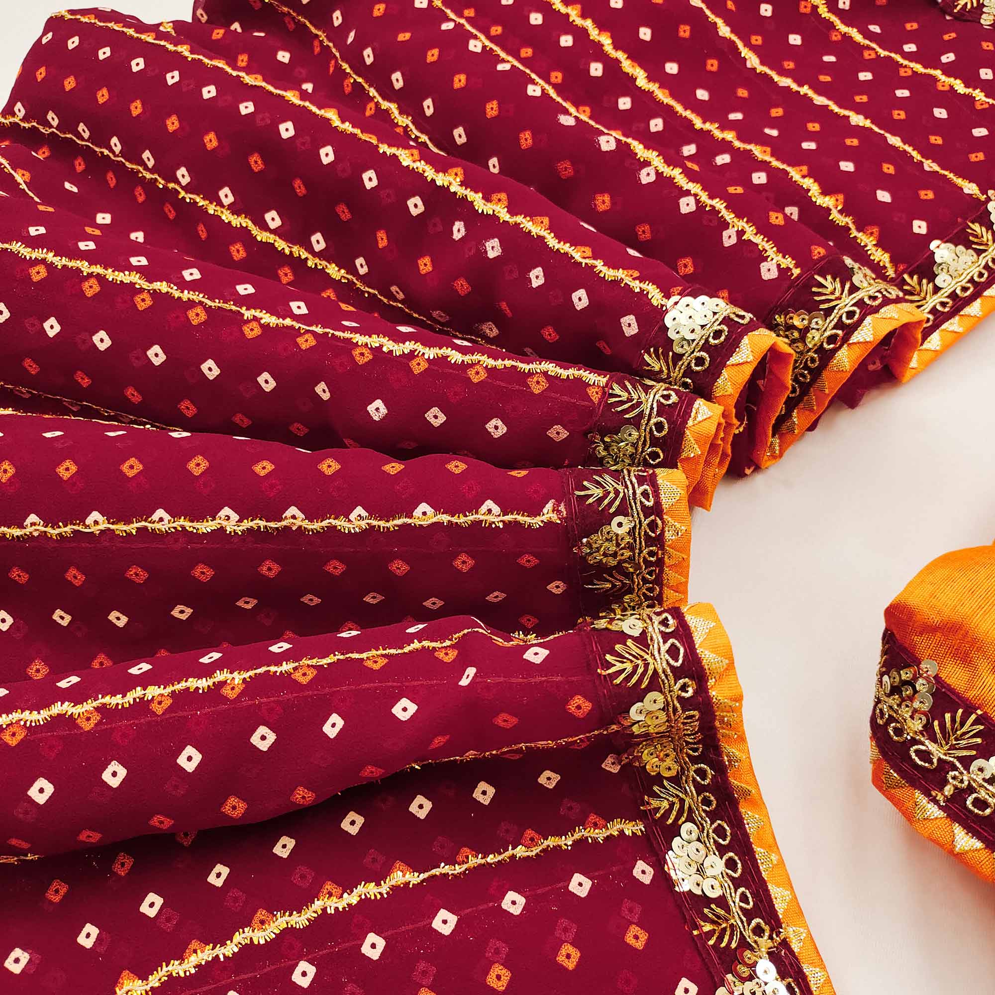 Charming Maroon Bandhani Printed Georgette Saree With Glittering Sequins & Zari Border