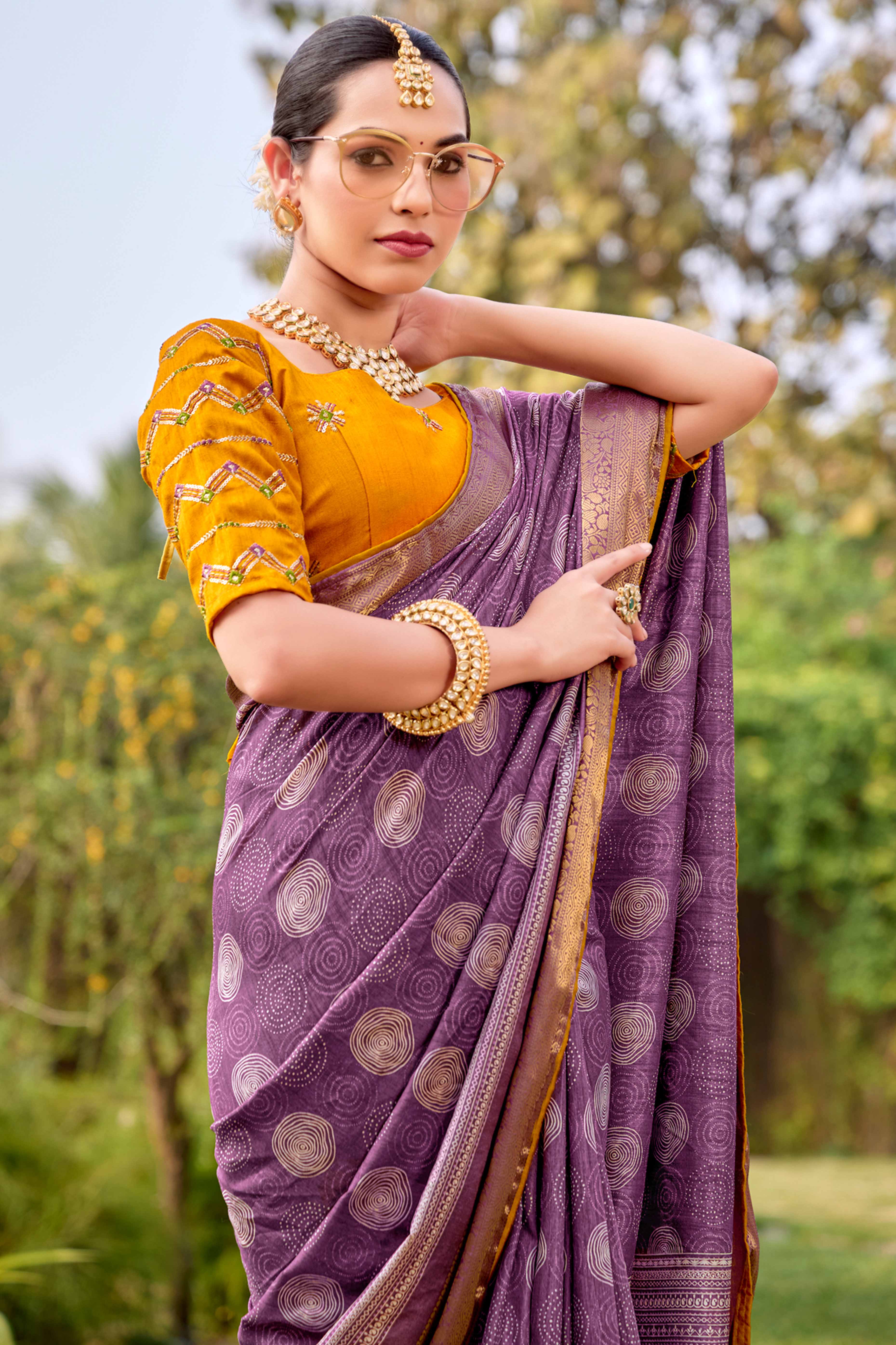 Purple Printed Dola Silk Saree With Ornate Zari Border & Tassel Pallu