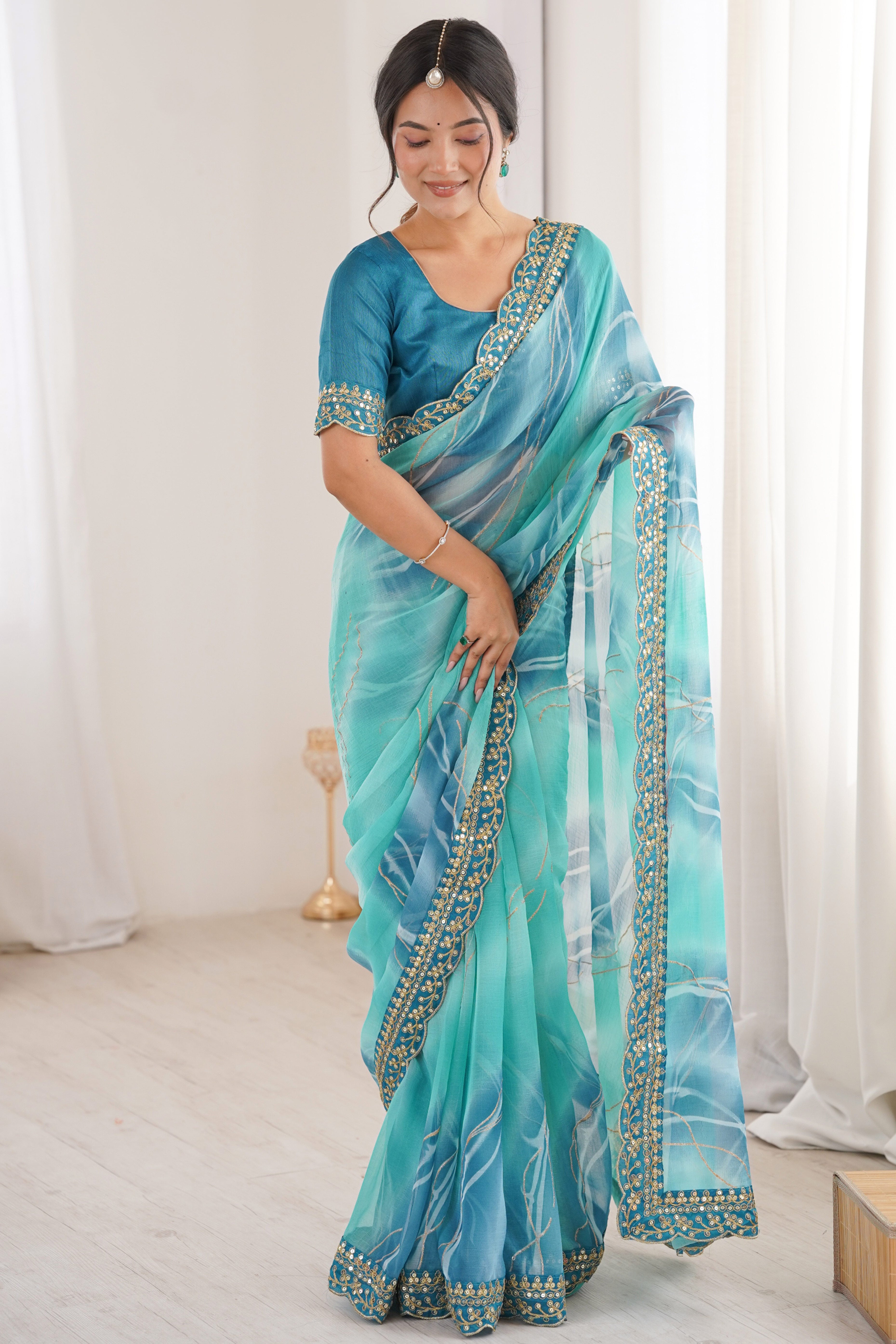 Graceful Blue Foil Print Georgette Saree Featuring A Luxurious Cording Sequins Embroidered Border