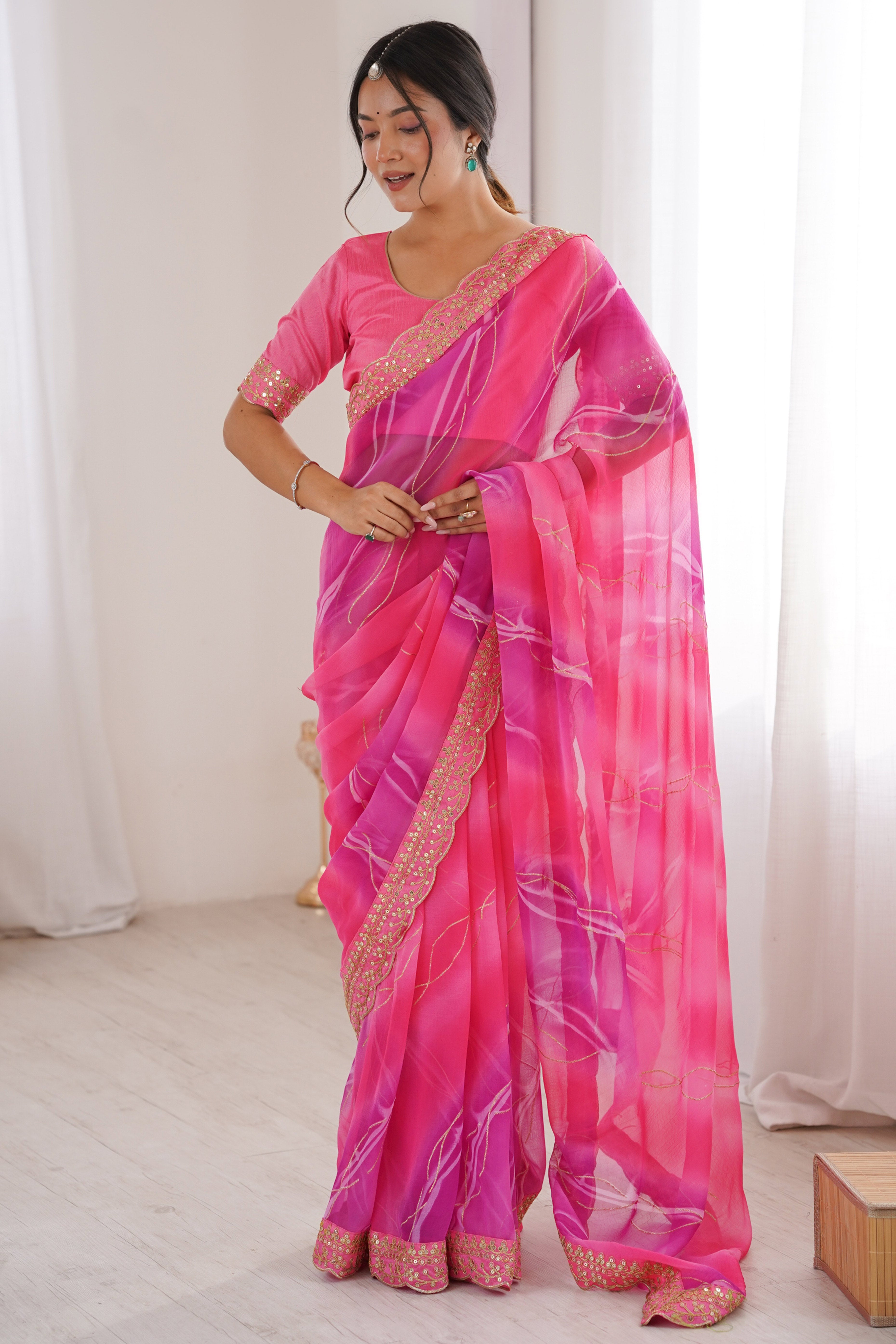 Graceful Pink Foil Print Georgette Saree Featuring A Luxurious Cording Sequins Embroidered Border