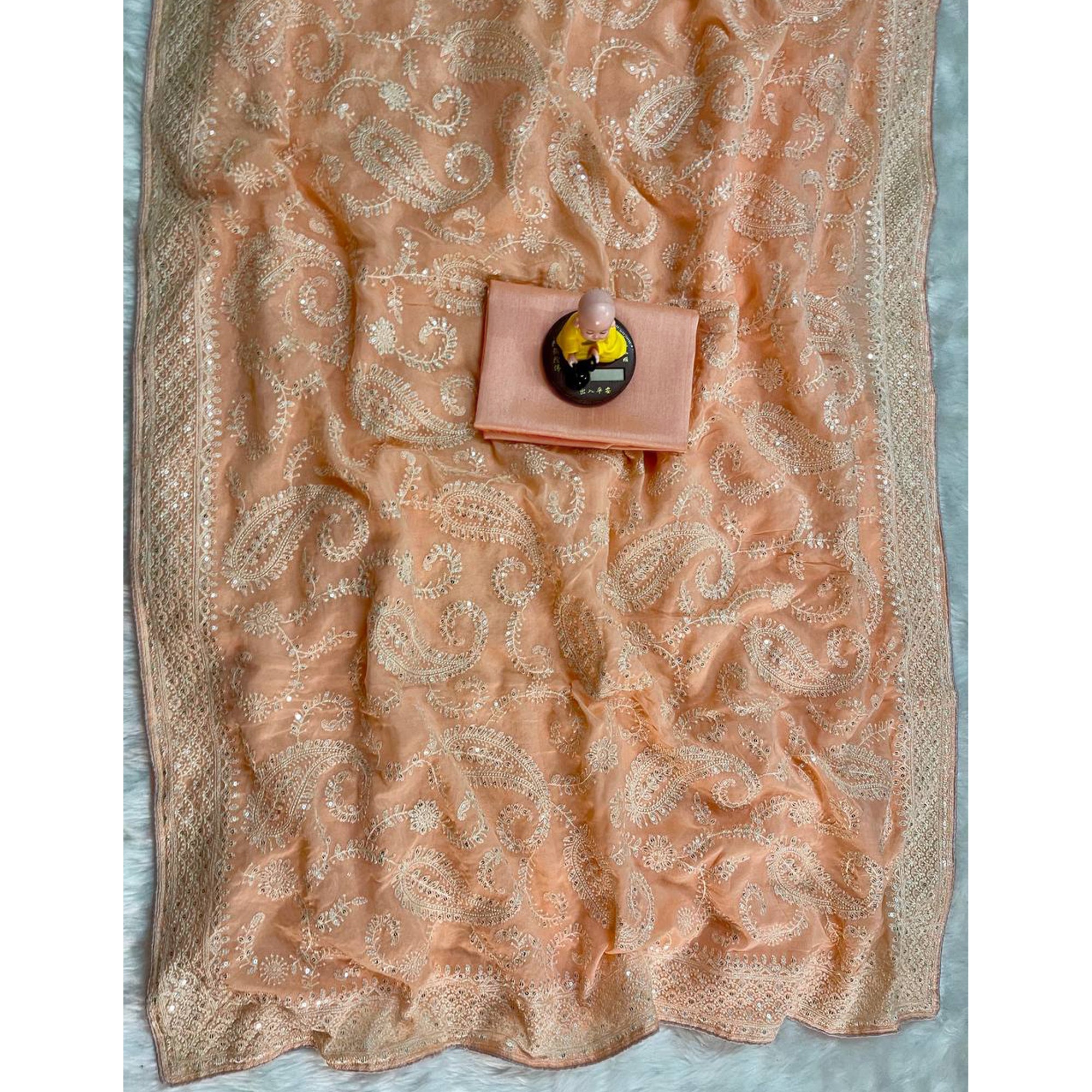Lustrous Light Orange Organza Silk Saree Beautified With Paisley Embroidery & Glittering Sequins