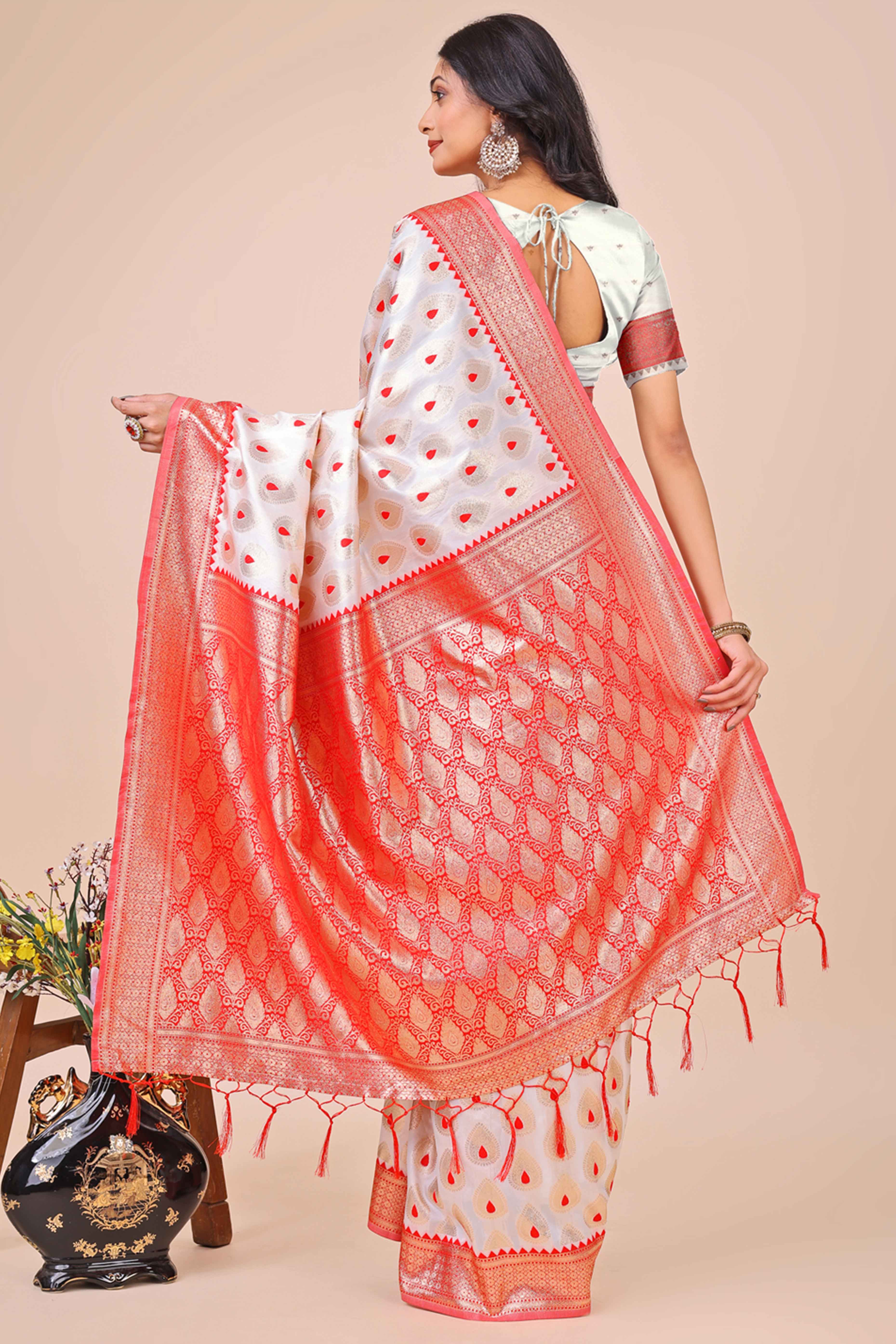 White Banarasi Silk Saree With Intricate Floral Weave & Elegant Tassel Accents