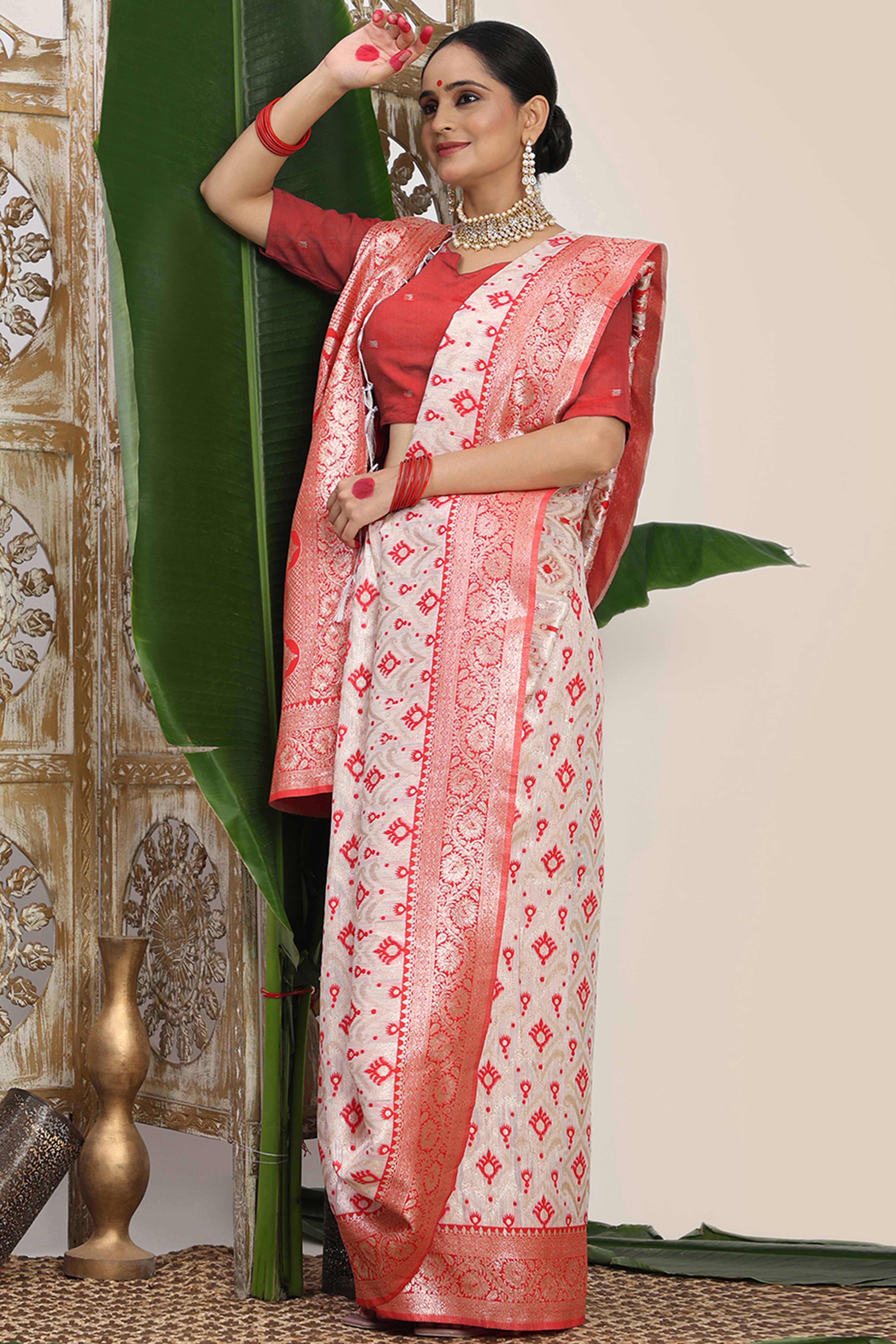 White & Red Linen Cotton Saree Accented With Rich Zari Weaving And A Decorative Tassel Pallu