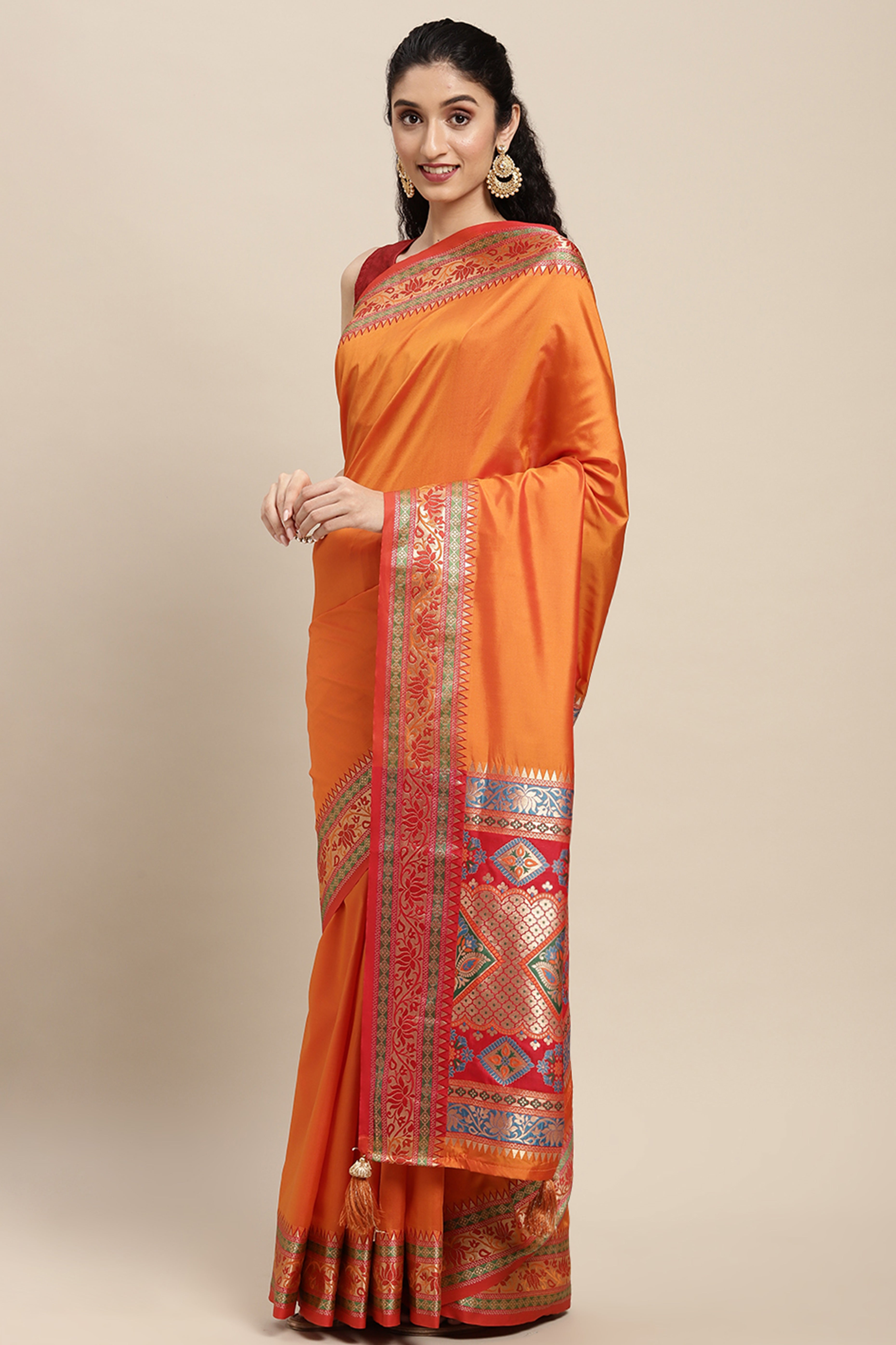 Graceful Orange Solid Saree Highlighted With Floral Zari Weaving On Silk Blend & Tassel Pallu