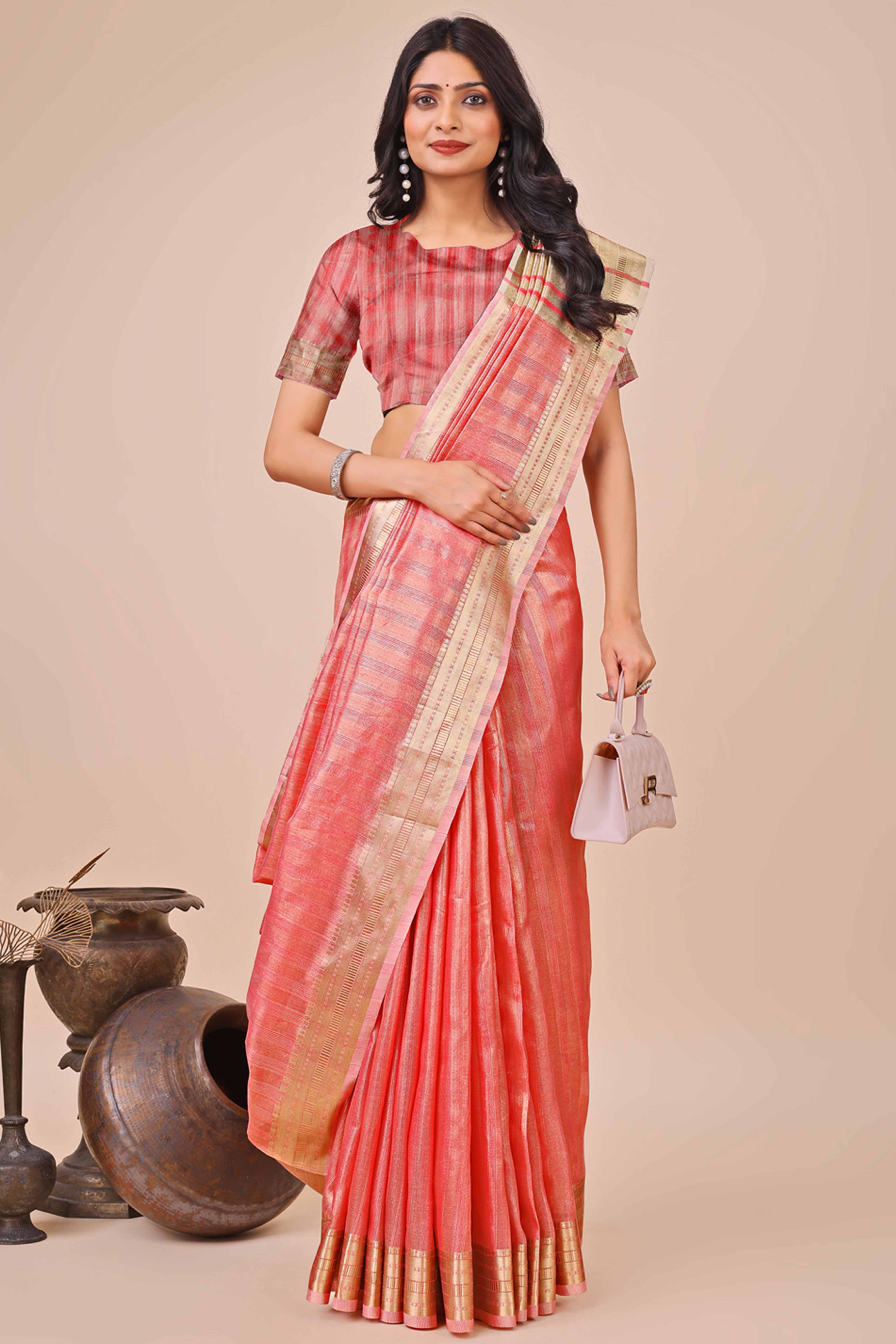 Coral Pink Organza Saree With Intricate Weave & Elegant Tassel Accents