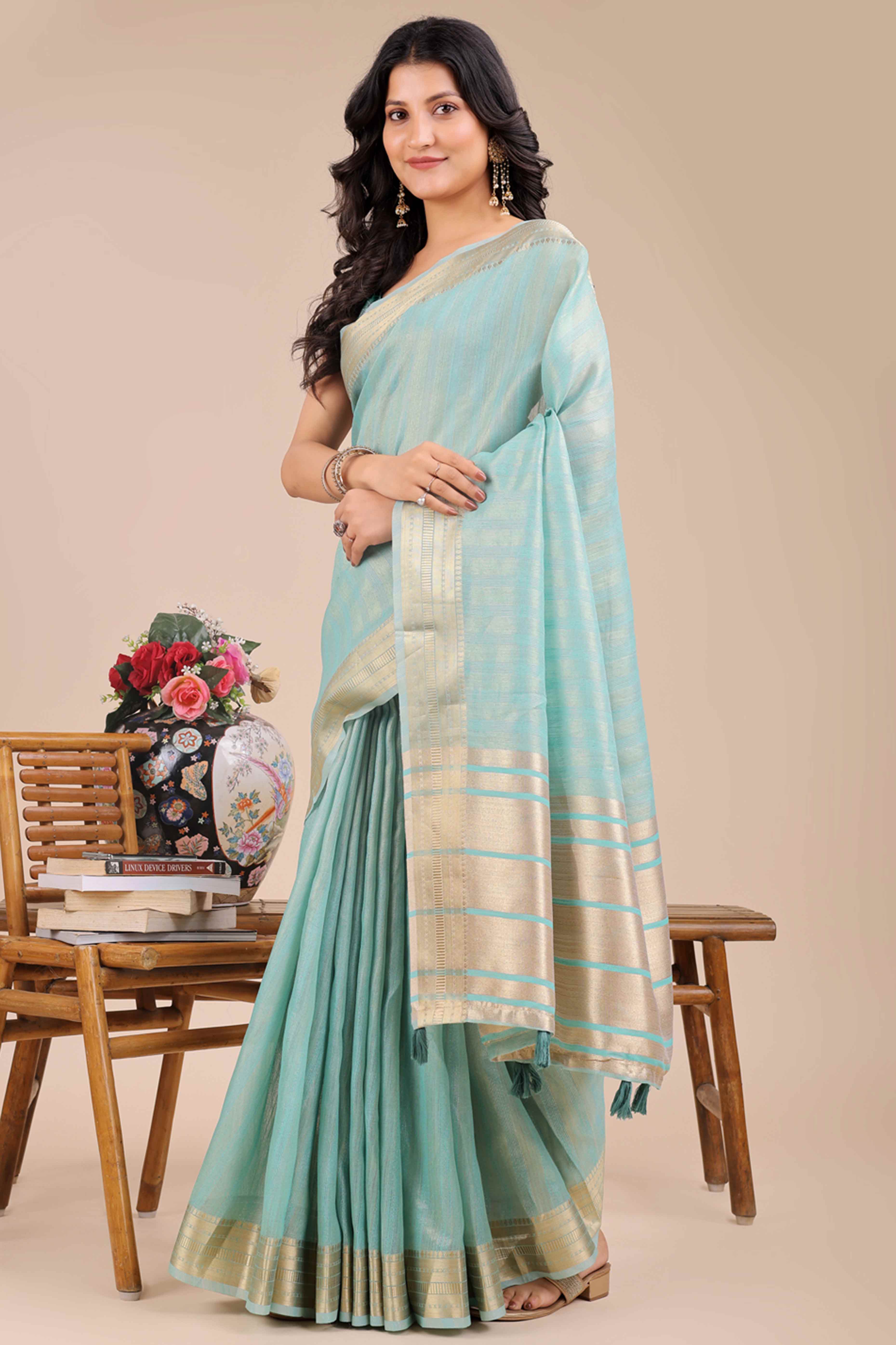 Light Turquoise Organza Saree With Intricate Weave & Elegant Tassel Accents