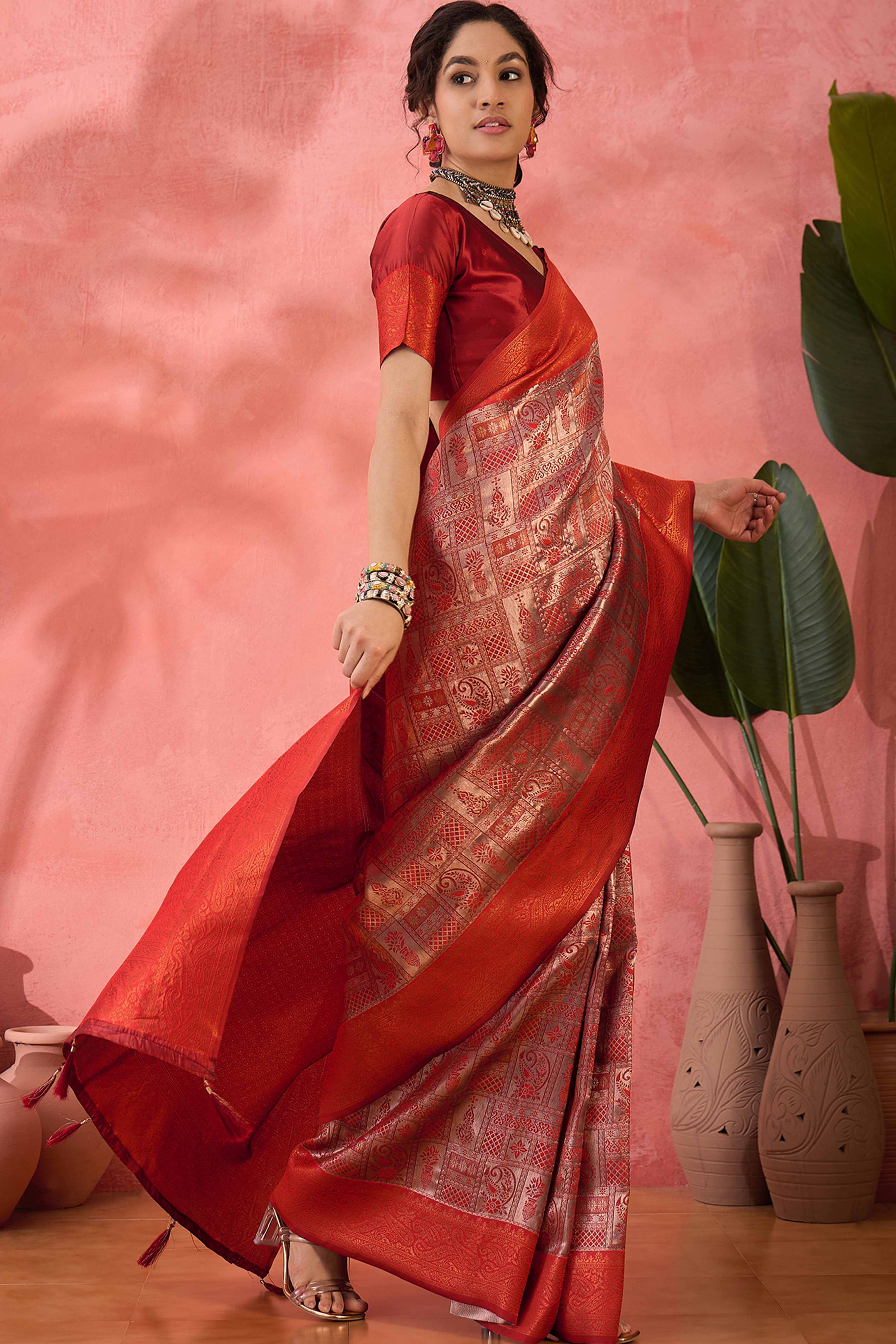Rust Woven Poly Silk Blend Saree Featuring Floral & Paisley Motifs With Tassel Accents