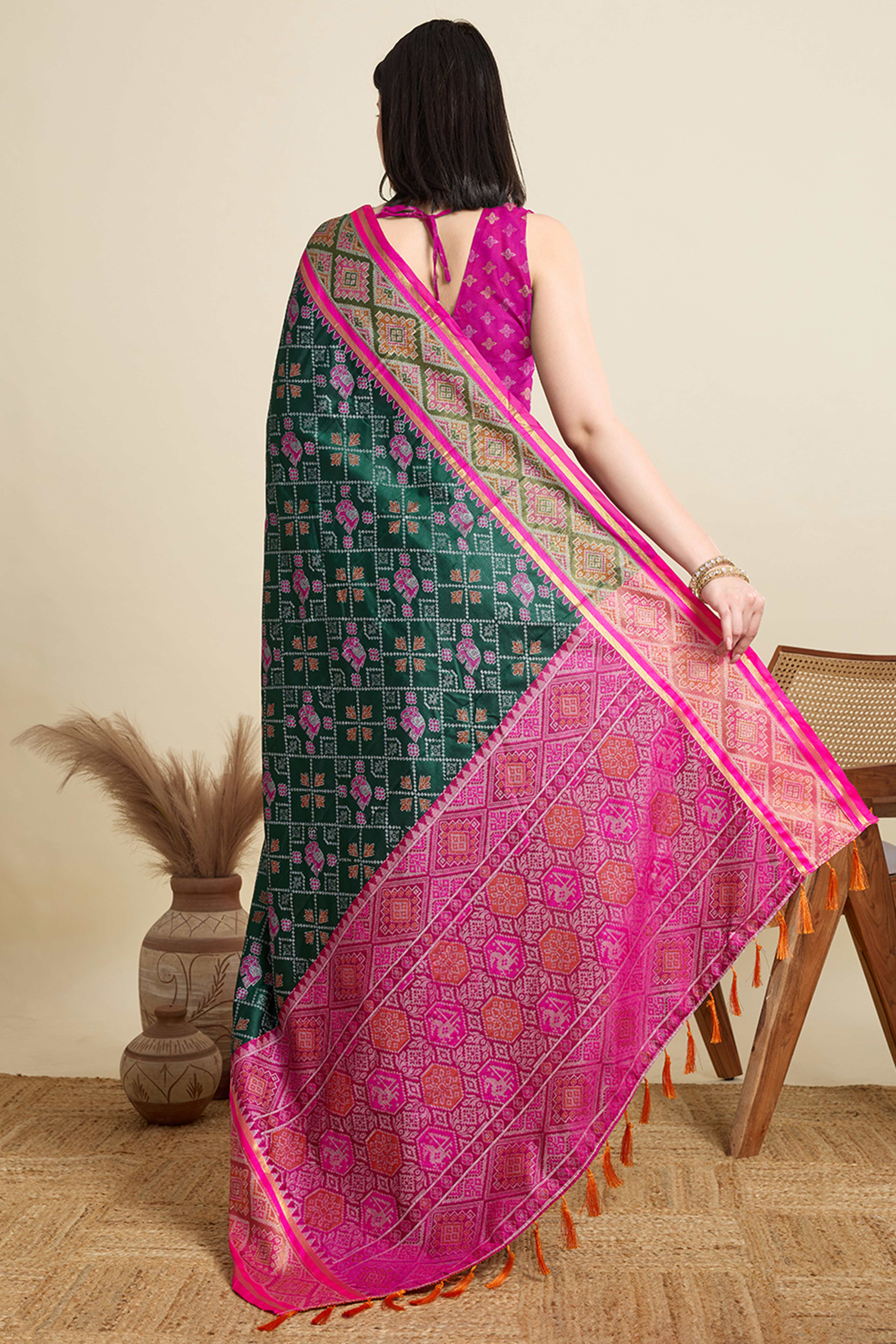 Green Silk Blend Saree Featuring Patola Prints and a Detailed Weaving Border