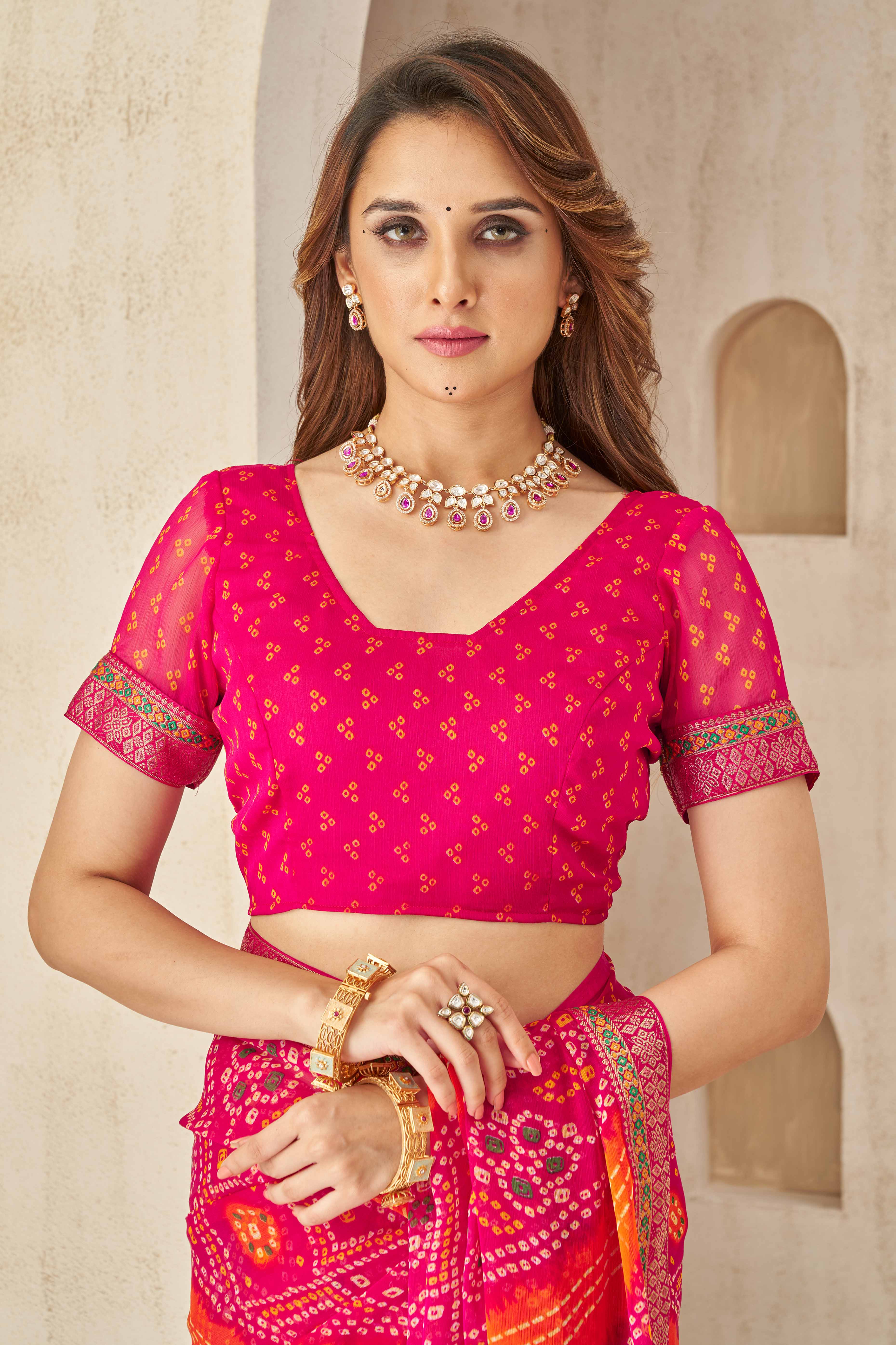 Magenta & Orange Bandhani Printed Chiffon Saree Enhanced with Delicate Lace Border Work
