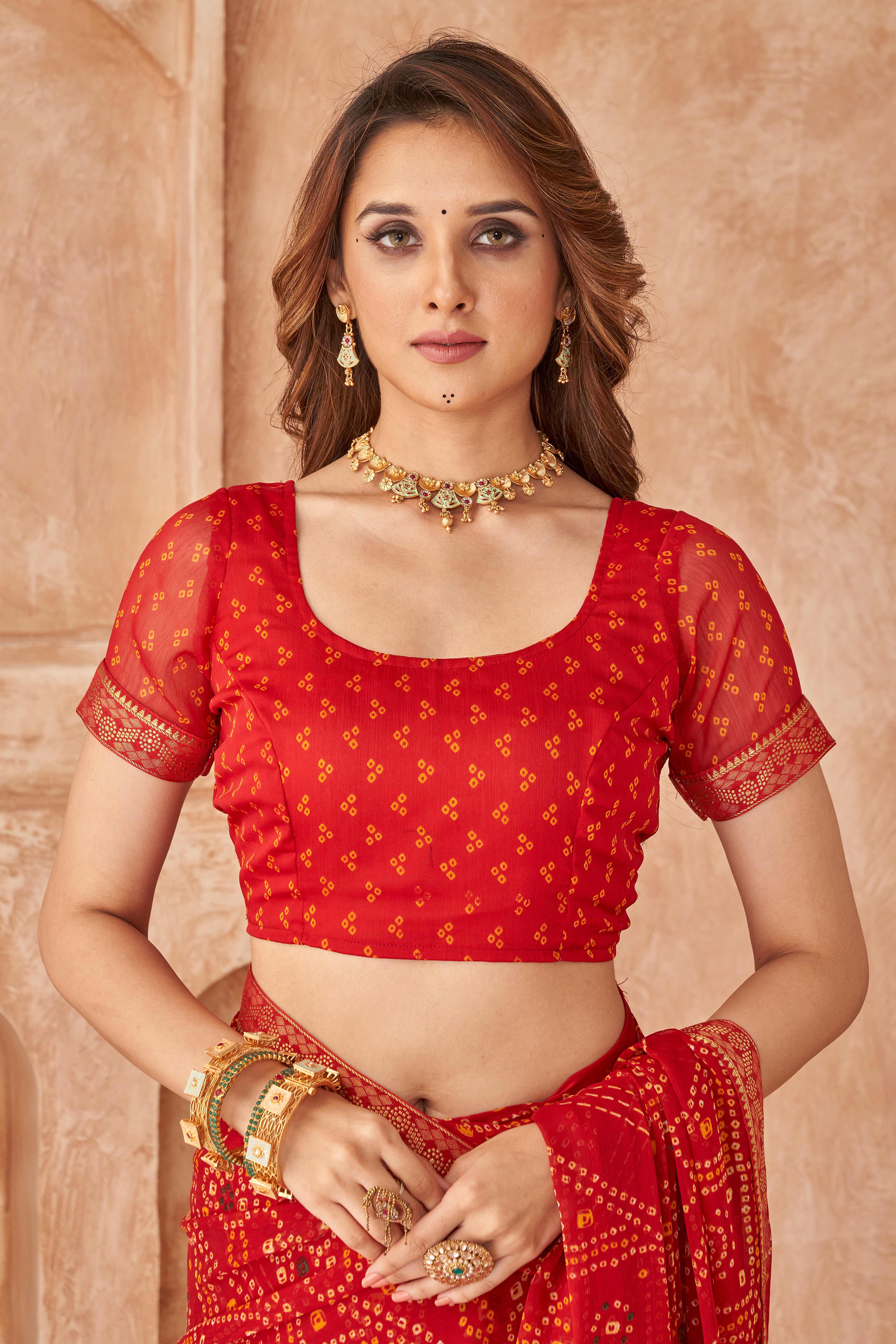 Red Chiffon Saree Featuring Traditional Bandhani Prints & A Graceful Lace Edge